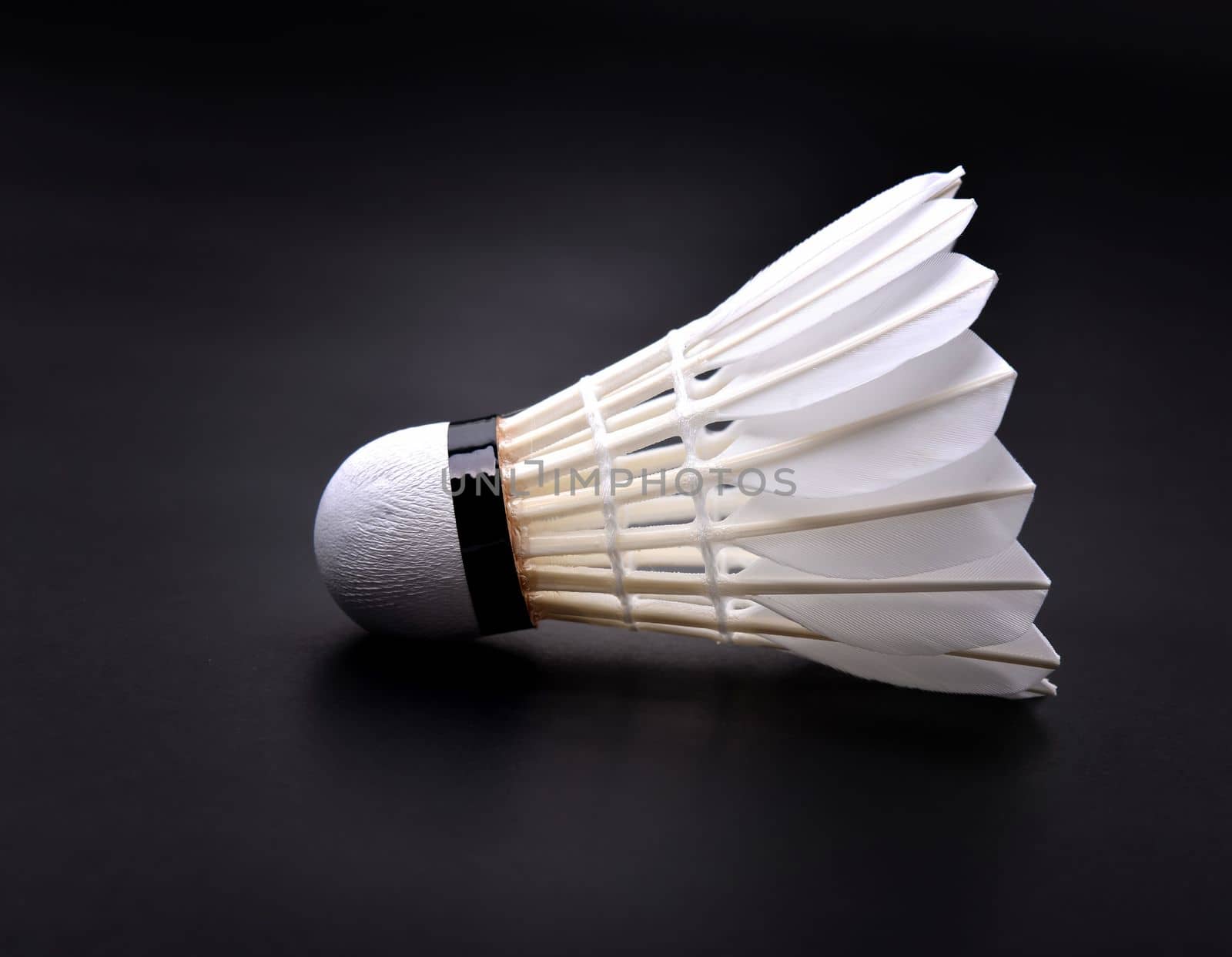 new shuttlecock on dark floor