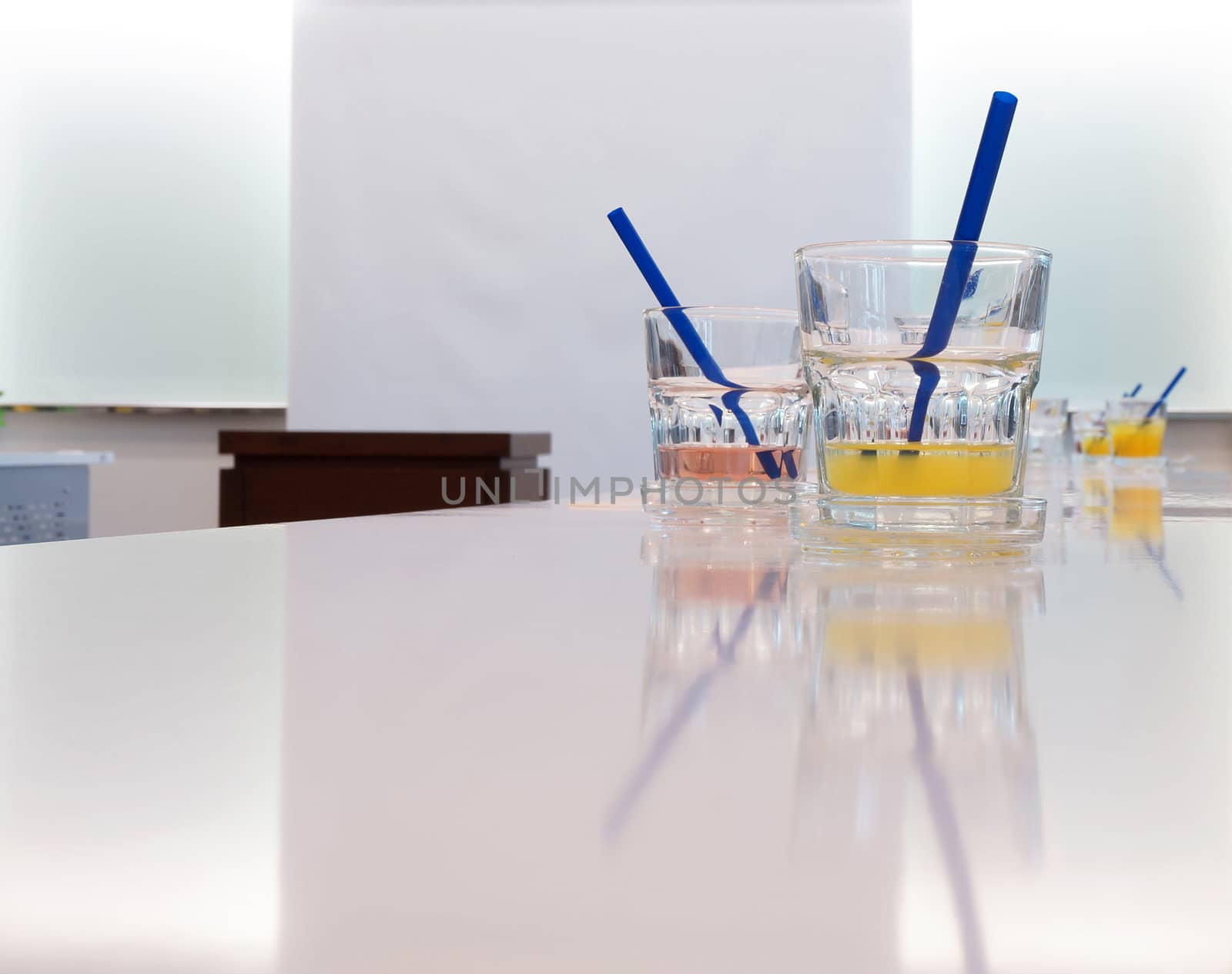 Glasses of juice in conference room by ninun