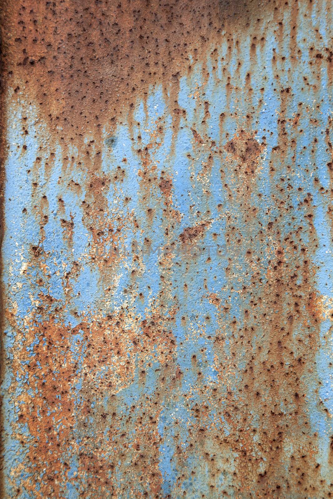 rusty metal with peeling blue paint by ahavelaar