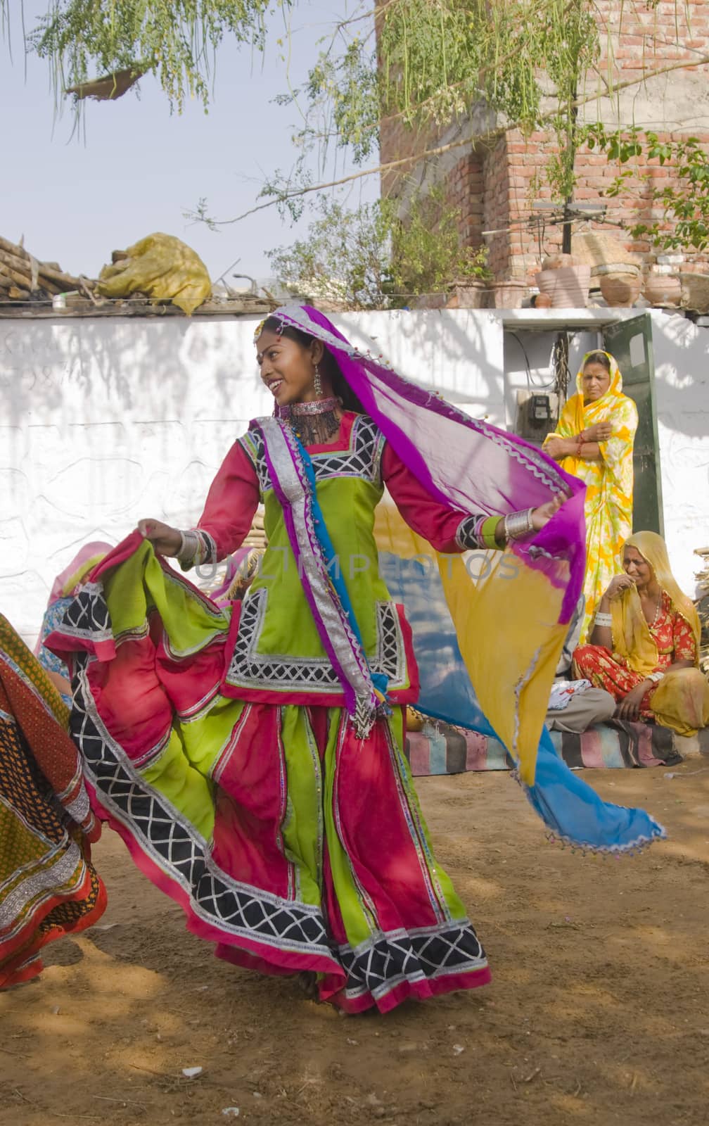 Beautiful tribal dancer in colorful costume performing in Jaipur, Rajasthan, India