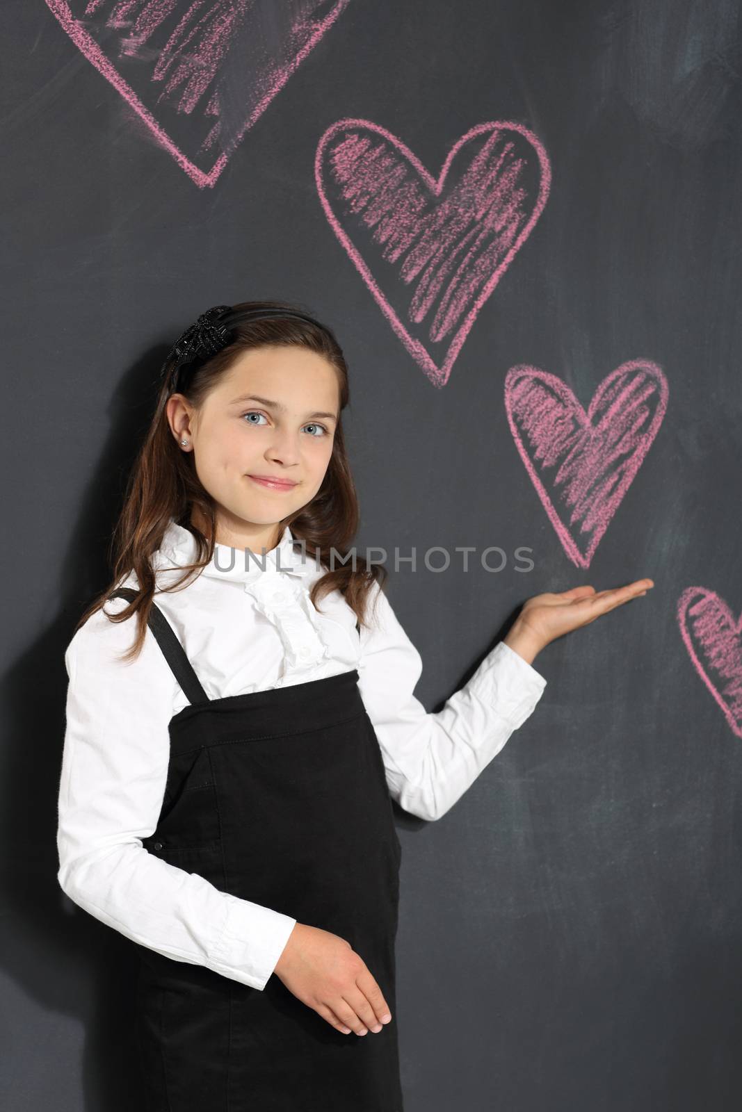 Girl in school uniform on a black background plate