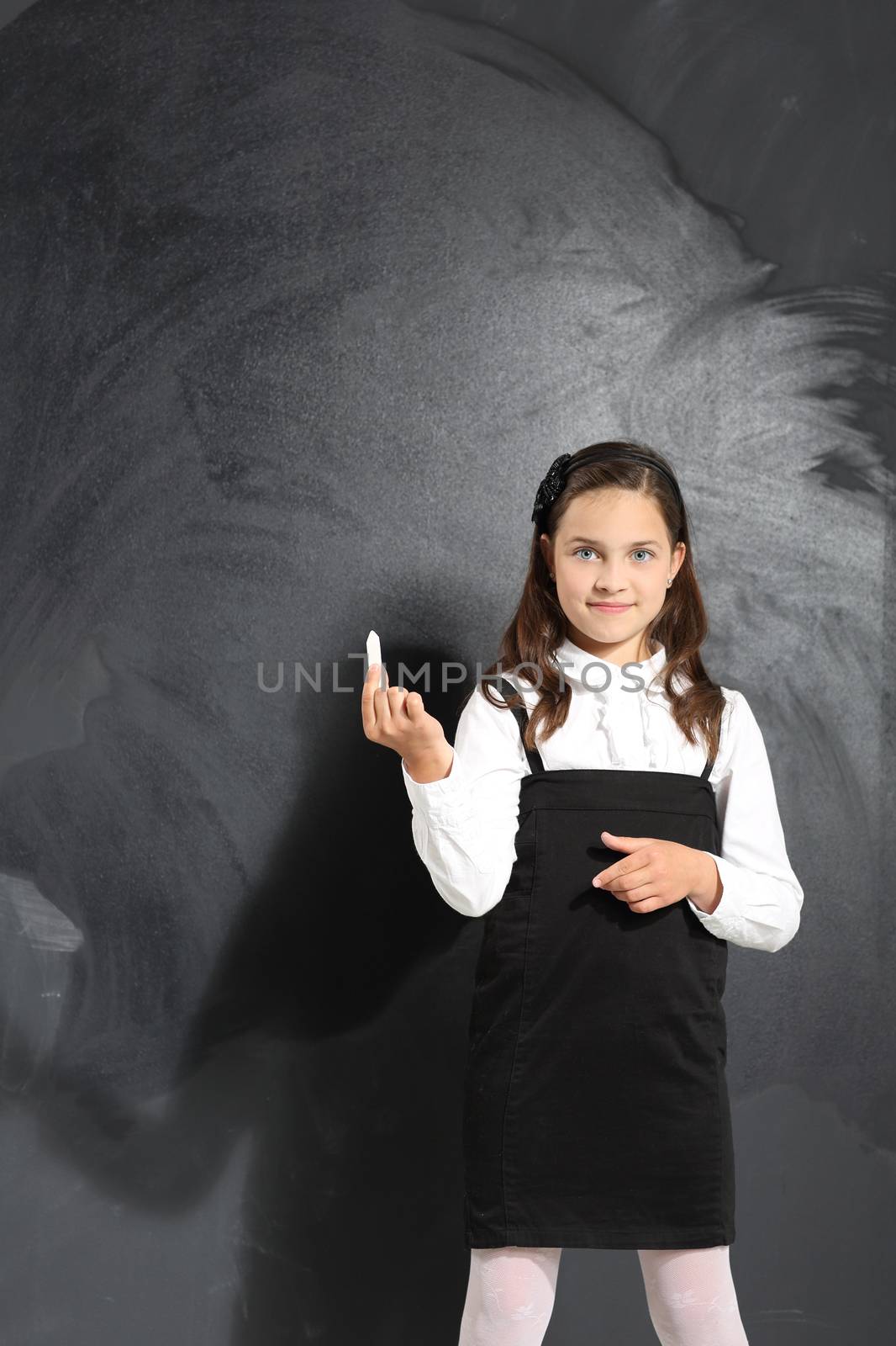 Cute little girl standing by a black school board by robert_przybysz