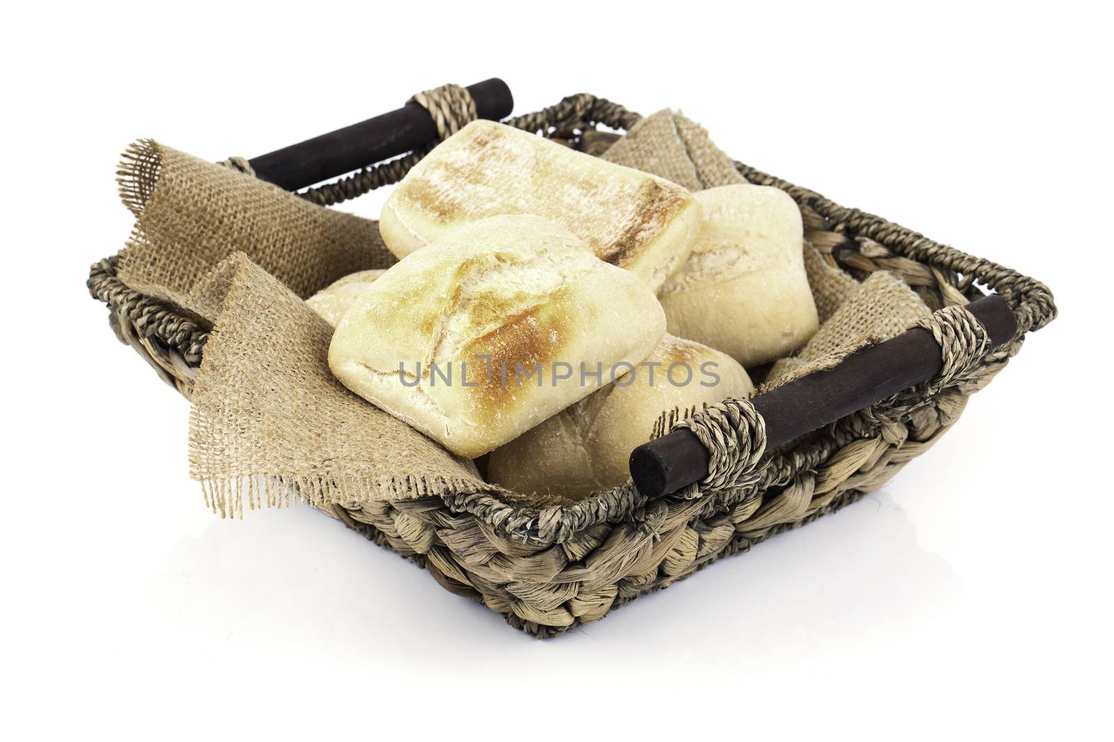 fresh baked buns in a basket on white background