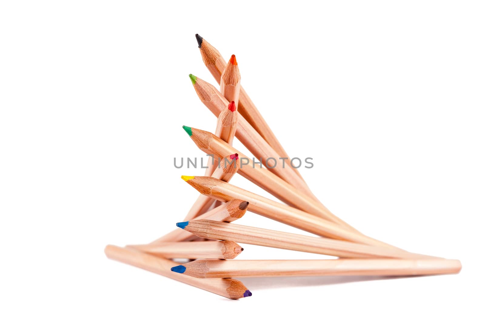creatively stacked pencils of different colors on white