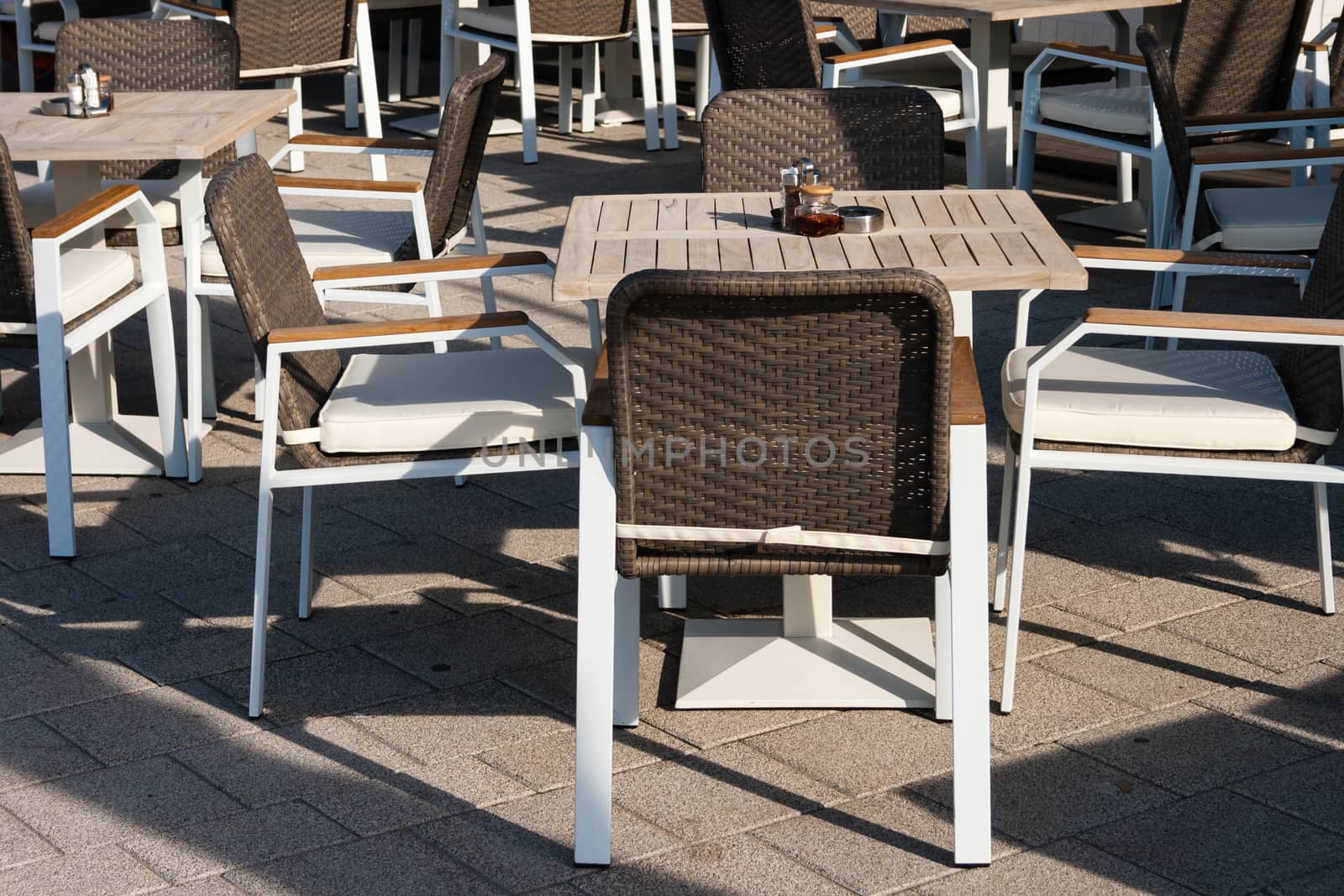 elegant restaurant tables with chairs placed outdoors