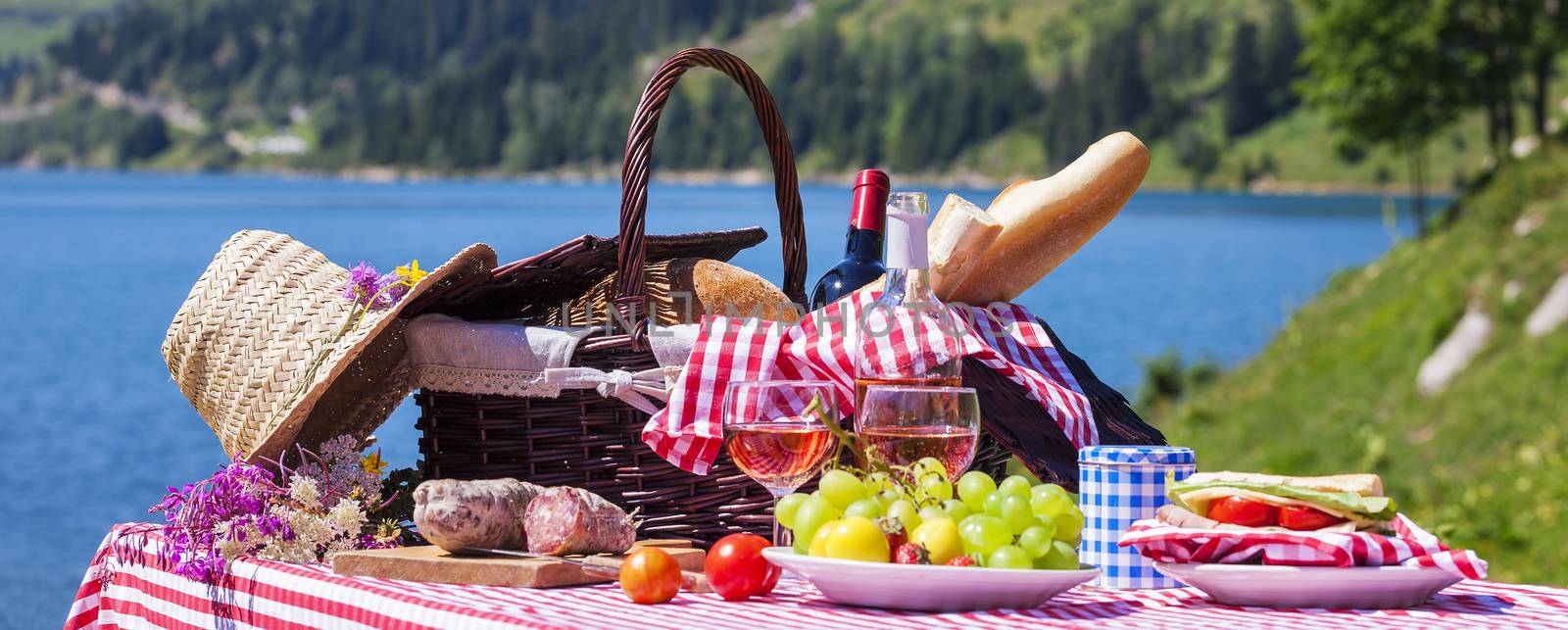 Picnic in french alpine mountains with lake on background, panoramic view