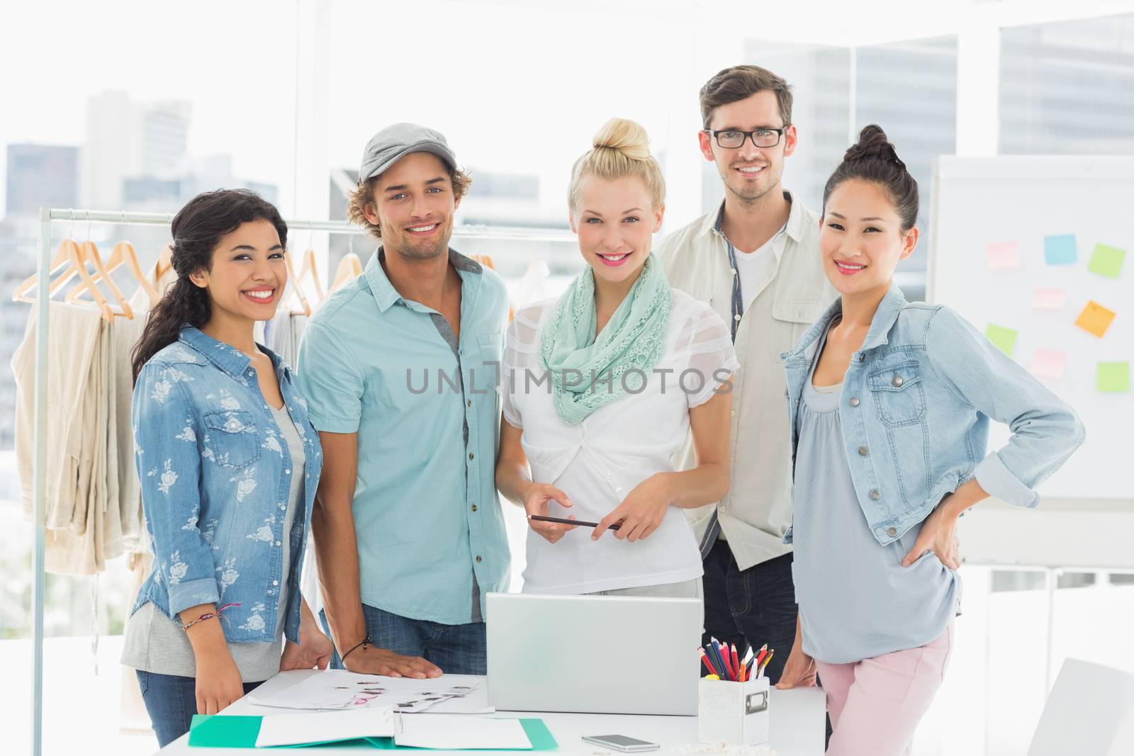 Group of fashion designers using laptop in a studio