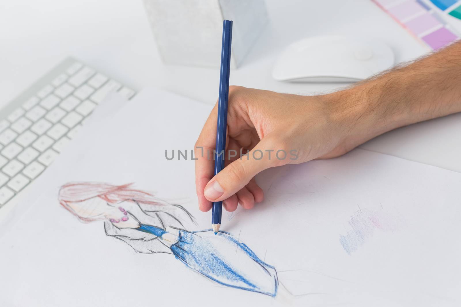 Extreme closeup of a fashion designer working on designs in the studio