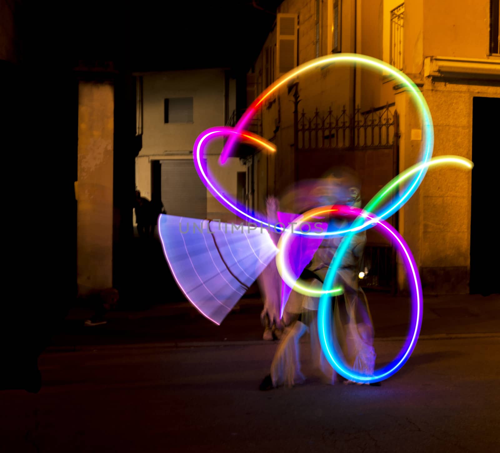 street artists, performances with led lights in the alleys of the city