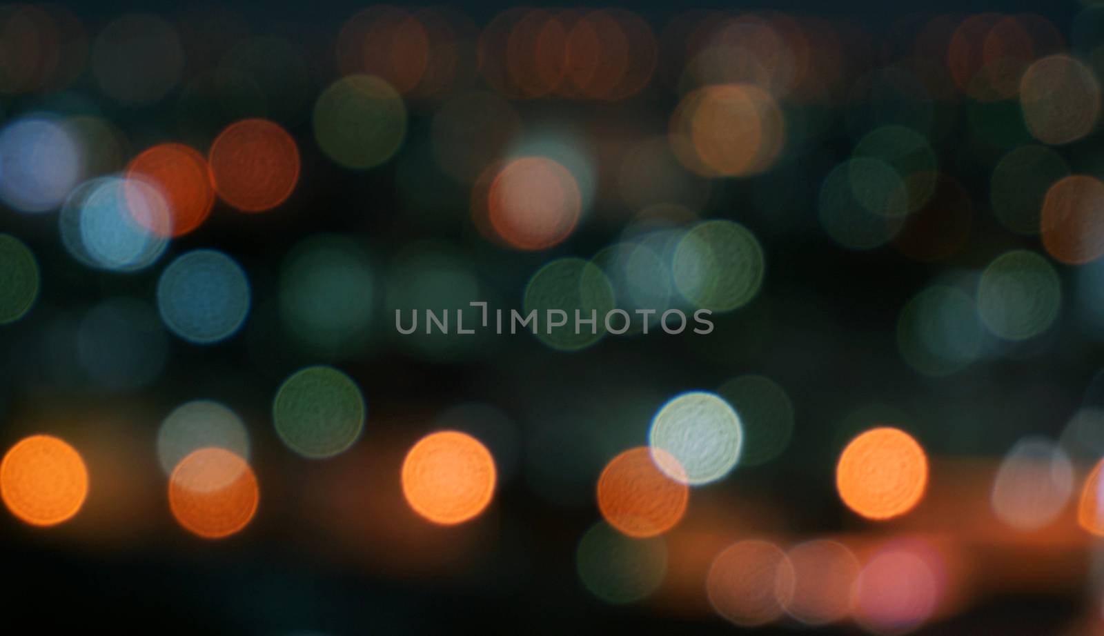 Night lights bokeh of variety of colors including red, green, yellow, blue, orange, pink and white.                                 