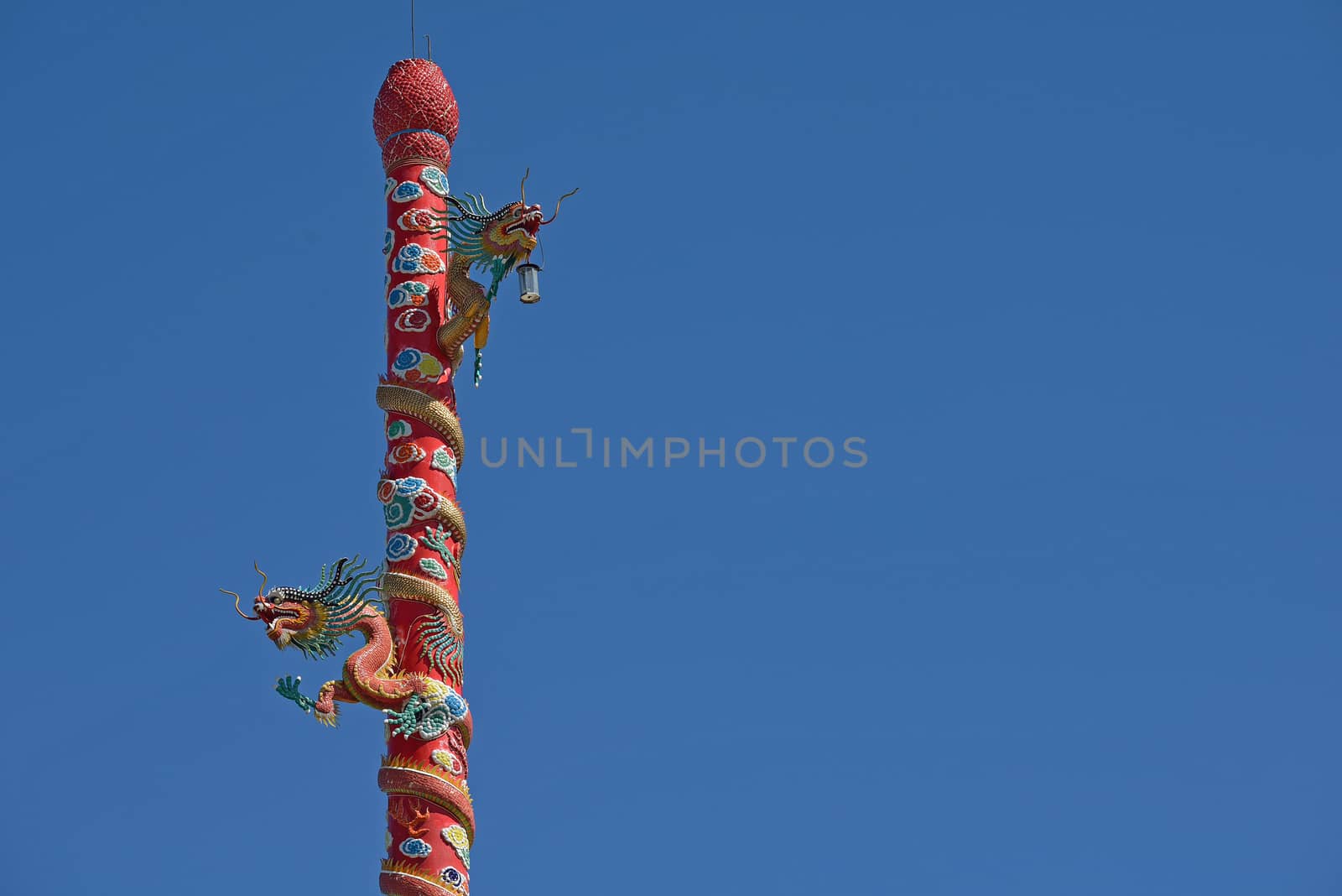 Dragon sculpture chinese style on the Chinese temple in Chonburi by think4photop
