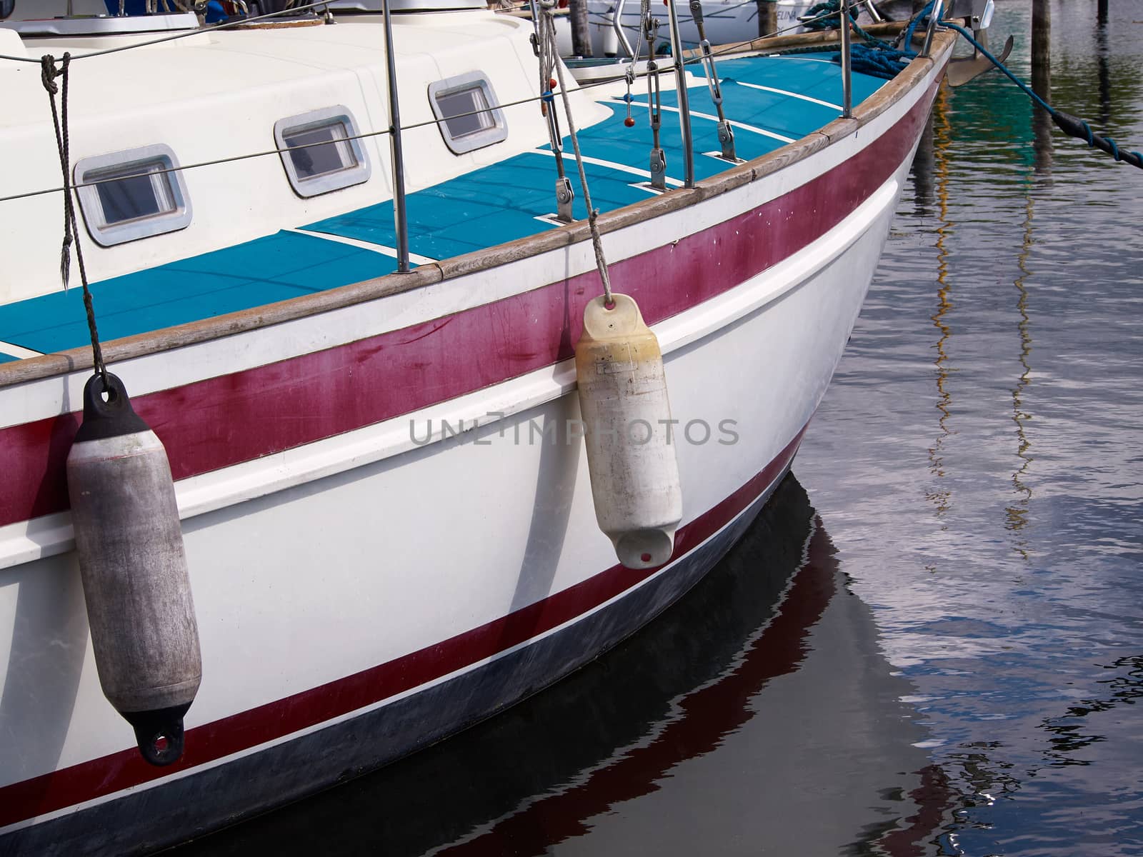 Reflection of an anchored yacht in the water sailing background    