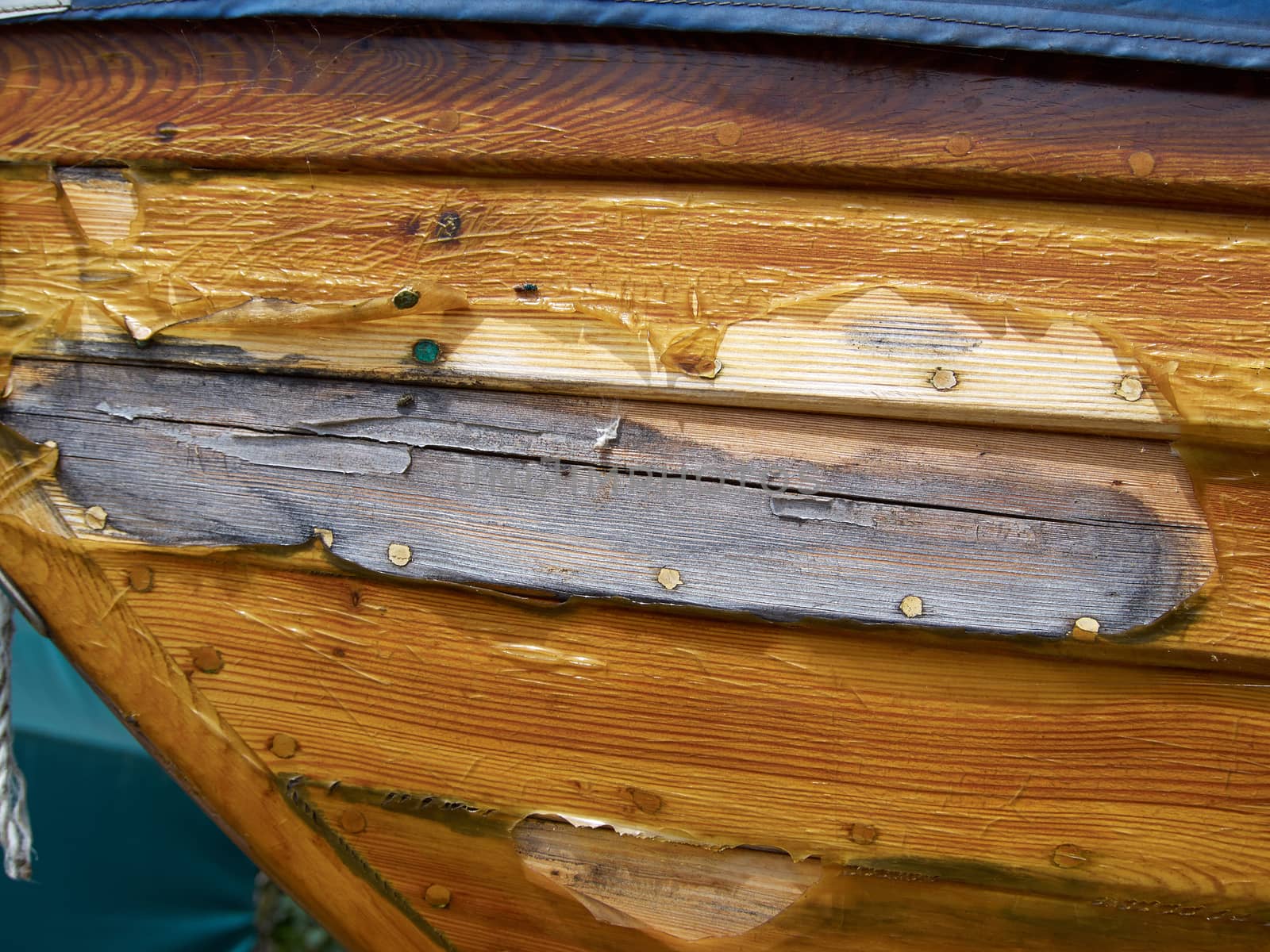 Prow of a small wooden boat with clear blue sky background 