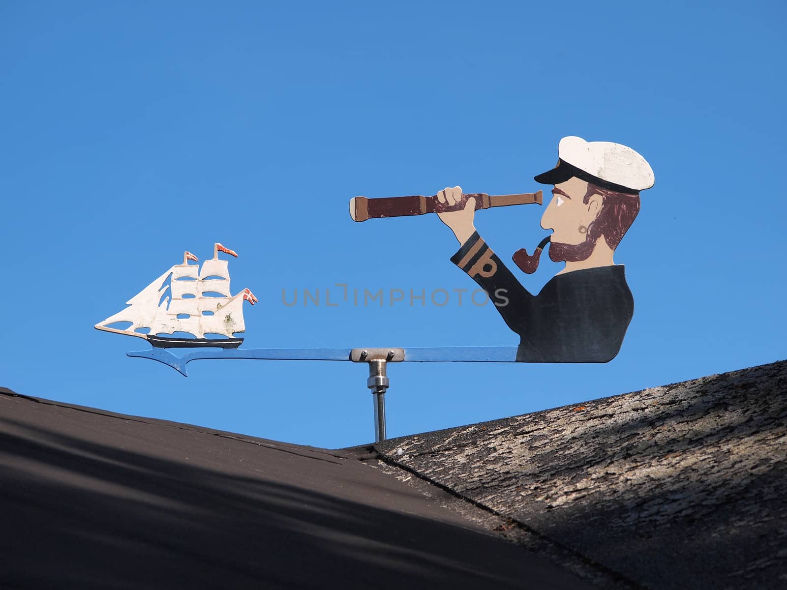 Marine weather vane shaped like a sailor blue sky background