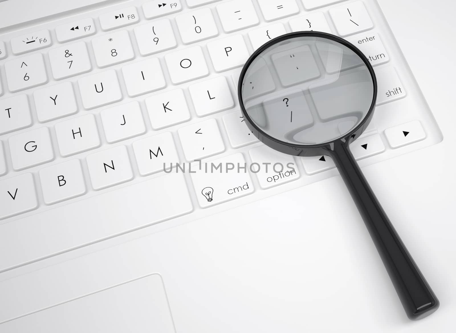 Magnifier glass on the keyboard. View from above