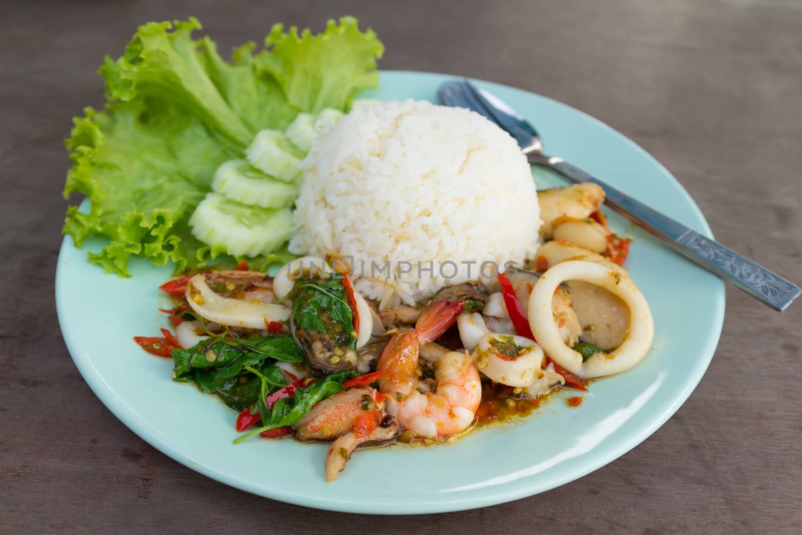 fried seafood with basil leaves on Steamed rice.