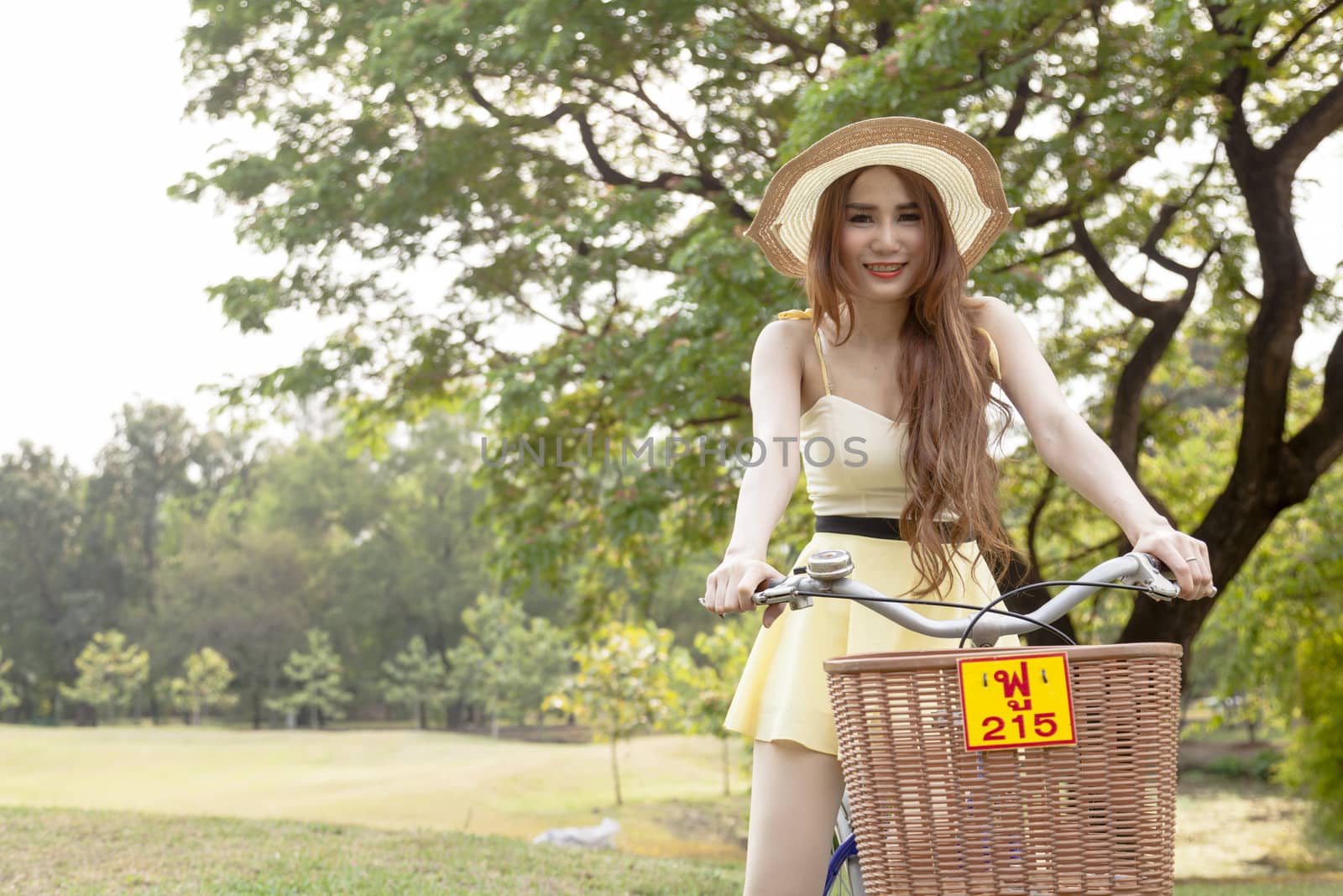 Woman riding a bicycle In the park Trees and peaceful