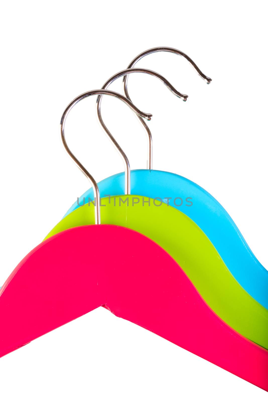 three colorful clothes hangers close up by kosmsos111