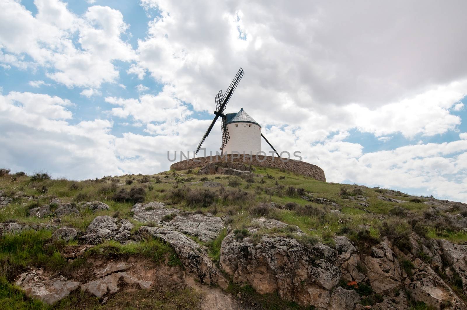 Old windmill on the hill, sky with clouds