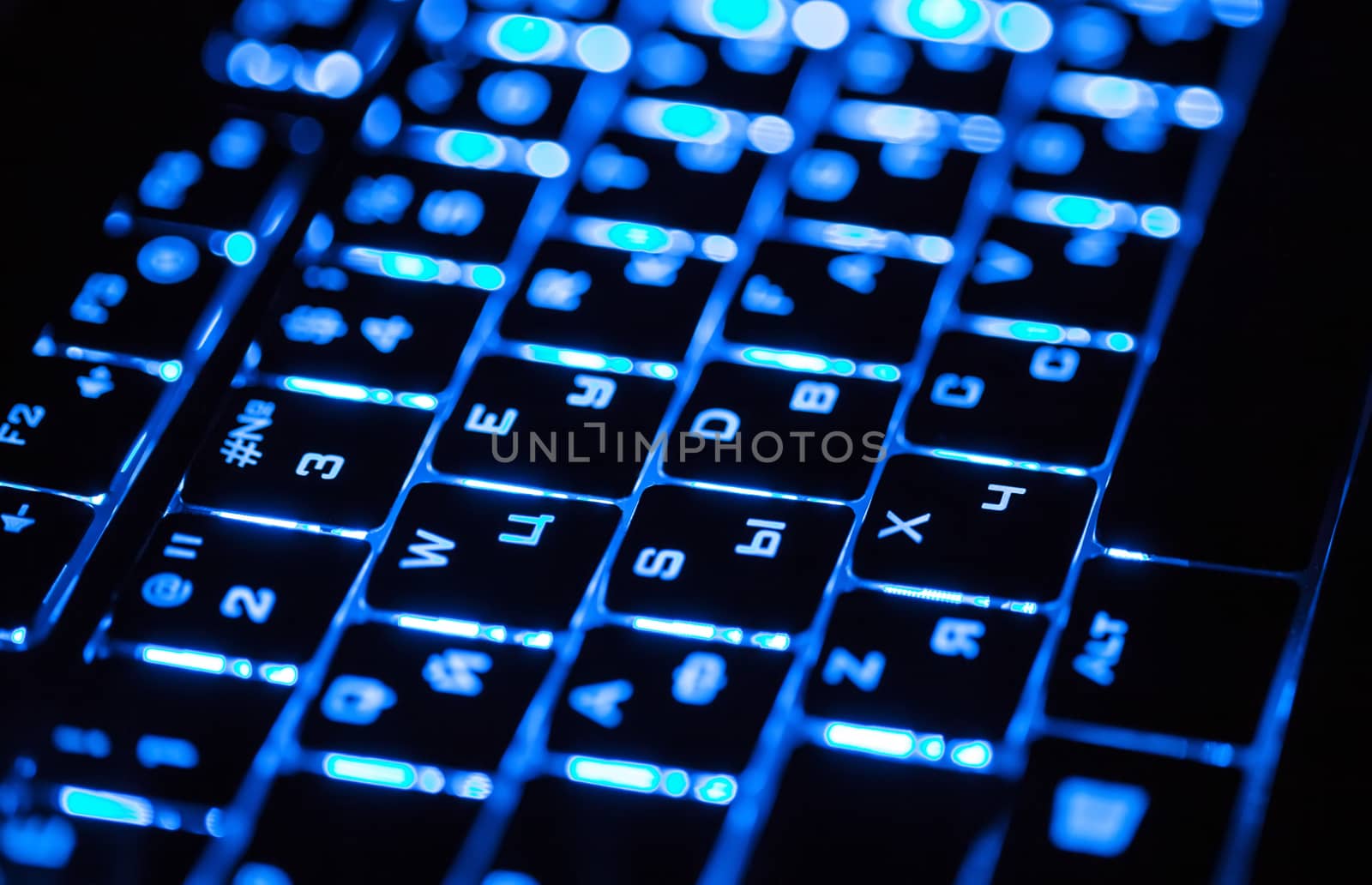 Blue lighting keyboard in the dark closeup by RawGroup