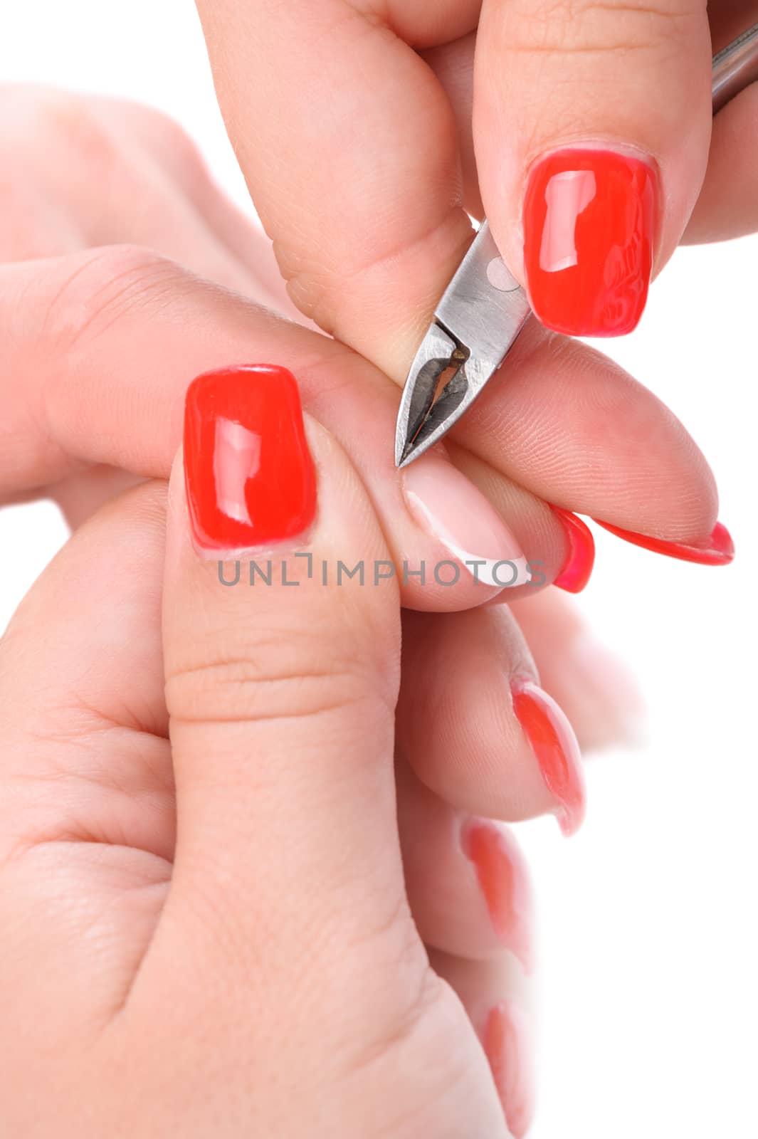 beauty salon, manicure applying, cutting the cuticle with scissors