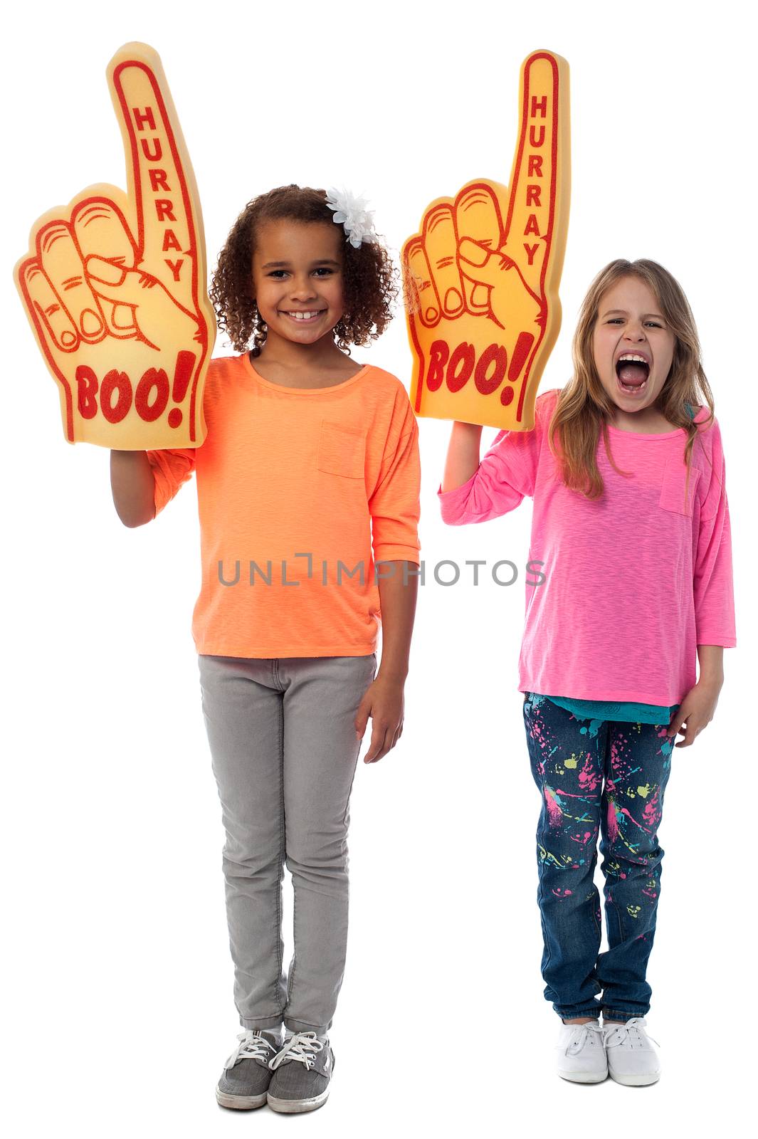 Little girls raises arms with foam finger by stockyimages