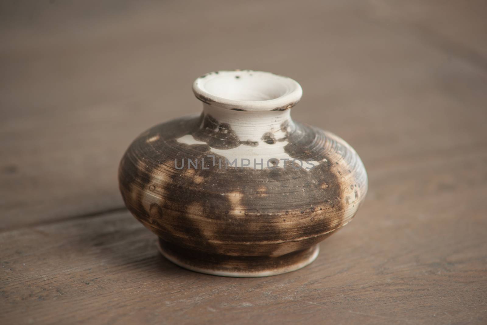 Traditional handcrafted vase of brown color on the table