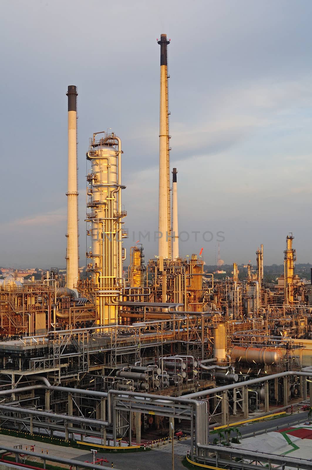 Oil Refinery factory at sunset by think4photop