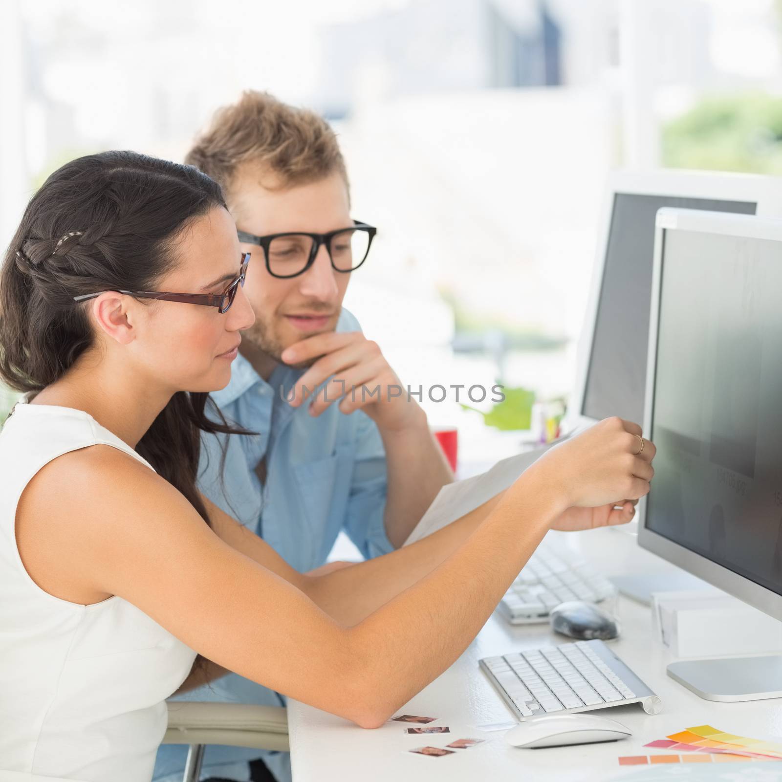 Creative partners working together at their desk by Wavebreakmedia