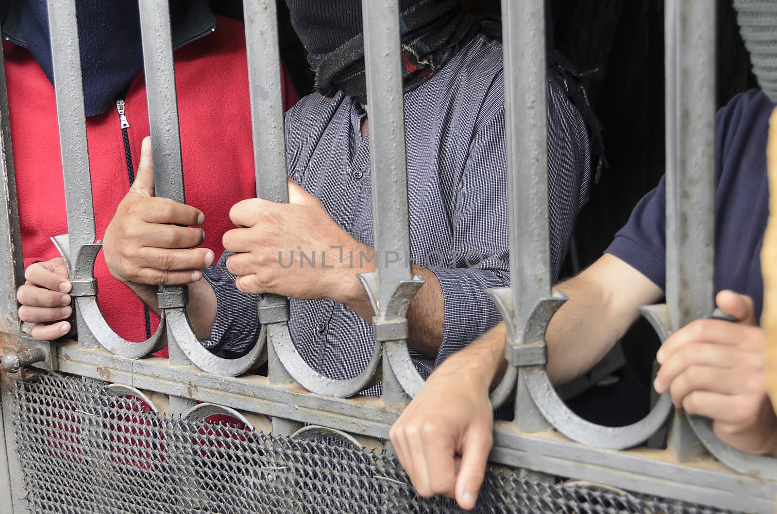 Workers barricaded behind bars for protesting the poor working conditions.