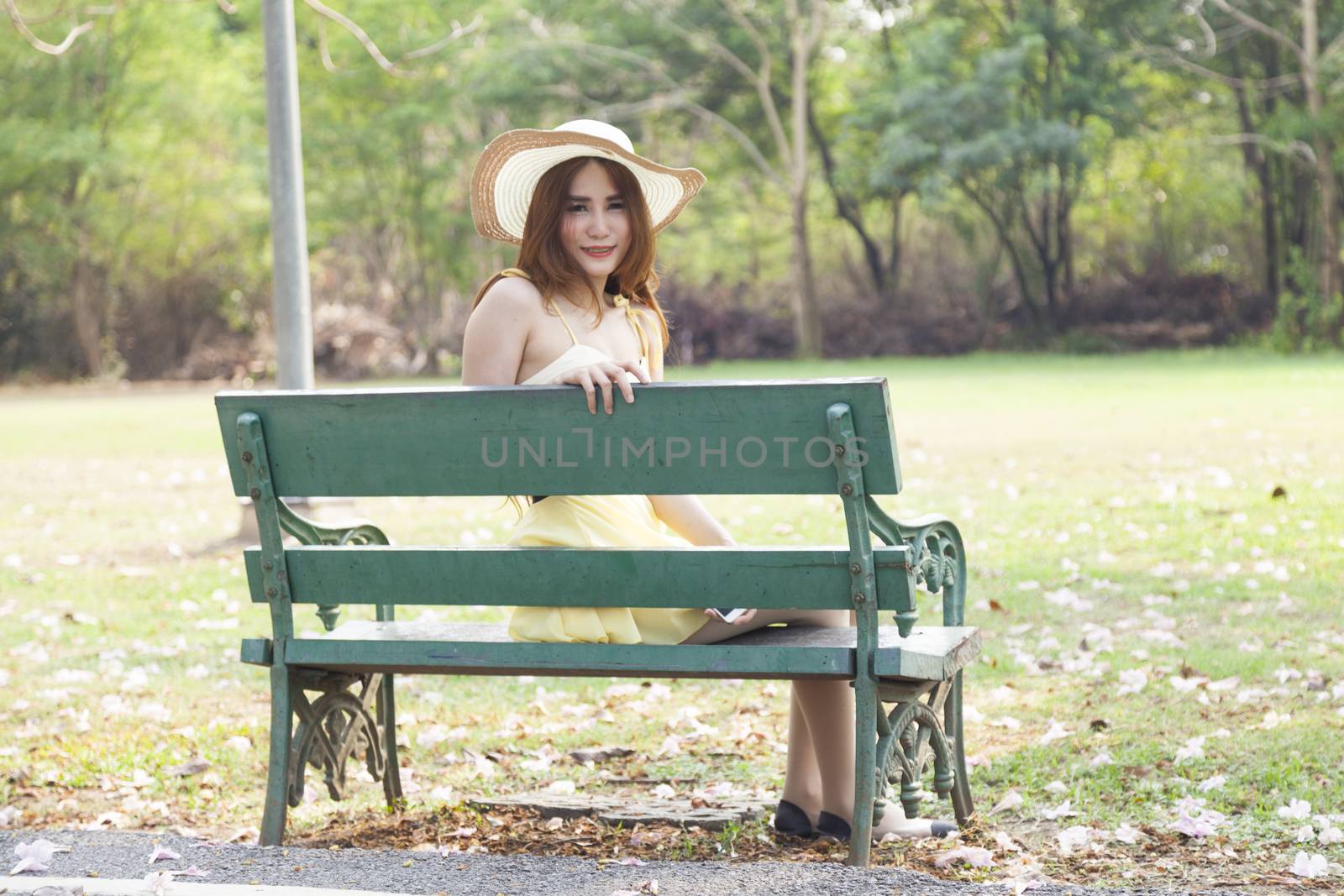Woman sitting on bench Benches on the lawn in the park.