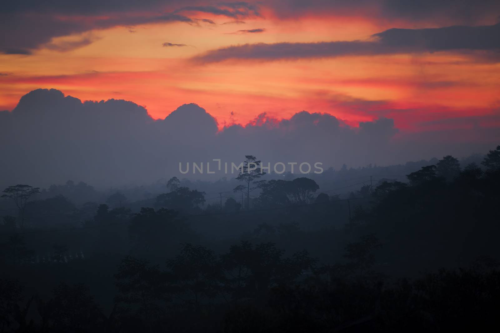 Misty sunset over the lush Balinese landscape
