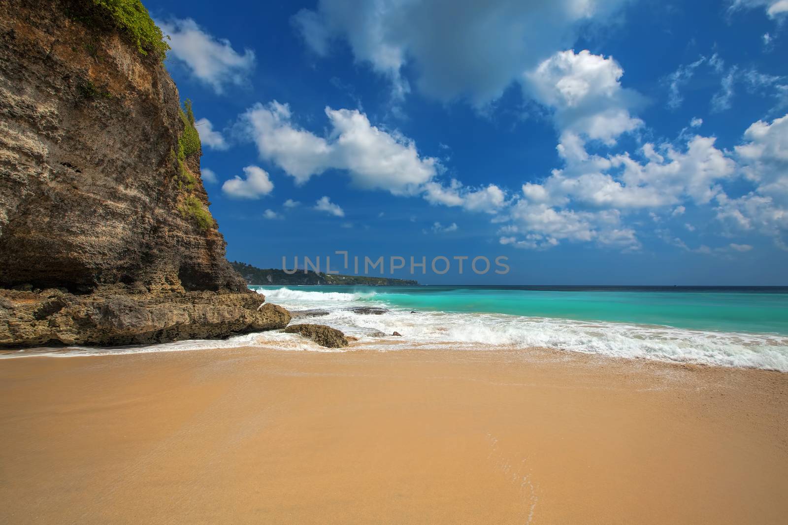 Surf waves and turqoise water along the coast of Bali