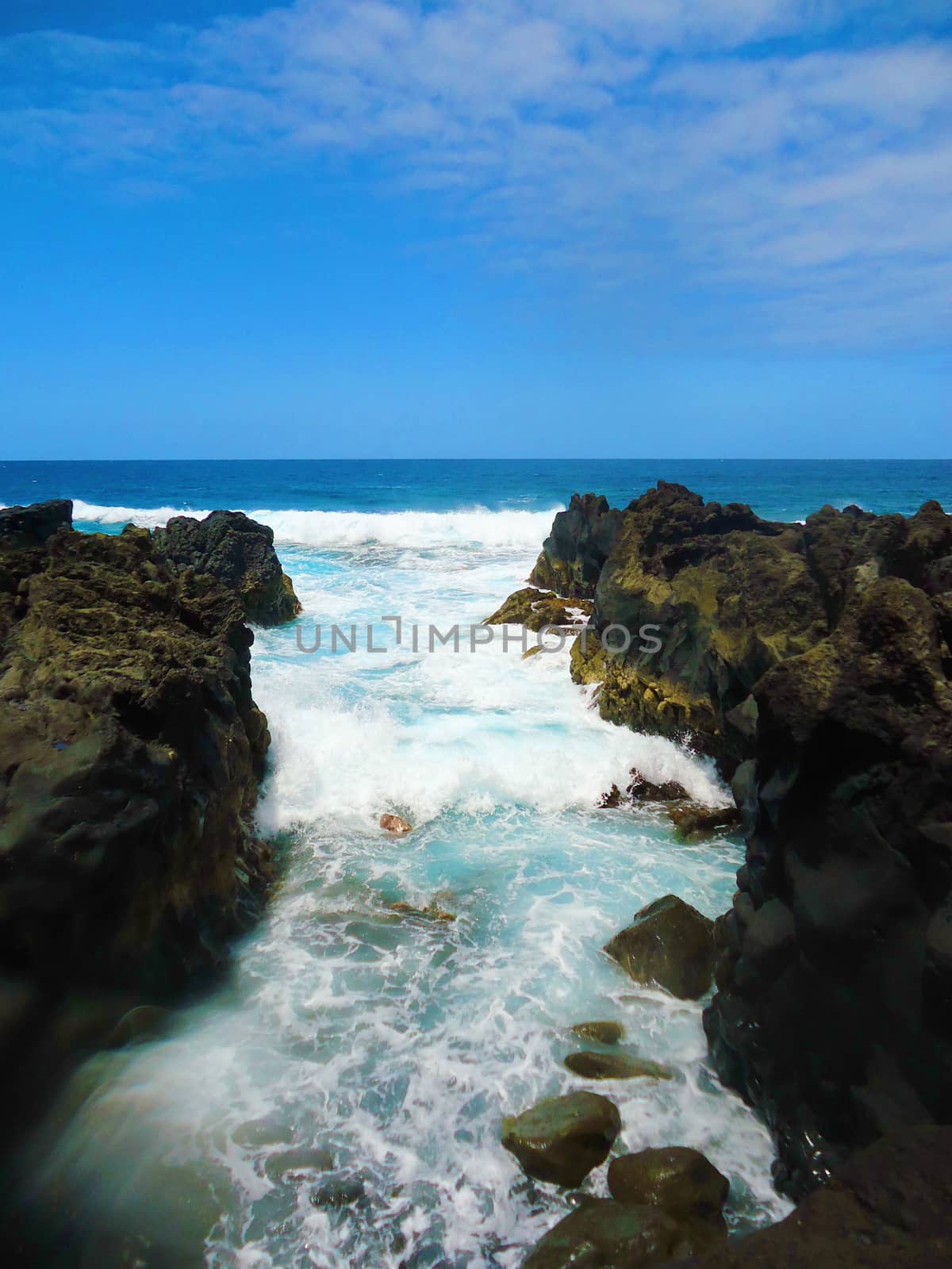 Ocean, big wave and splash over the stones in Spain