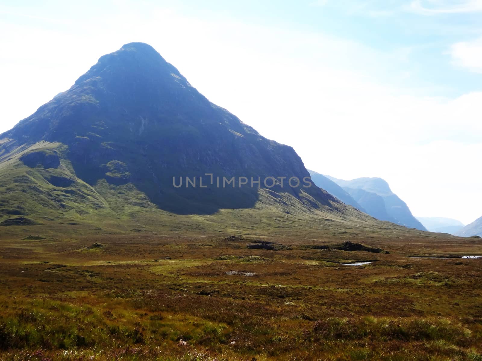 Scottish Highlands, mountain valley with blue sky