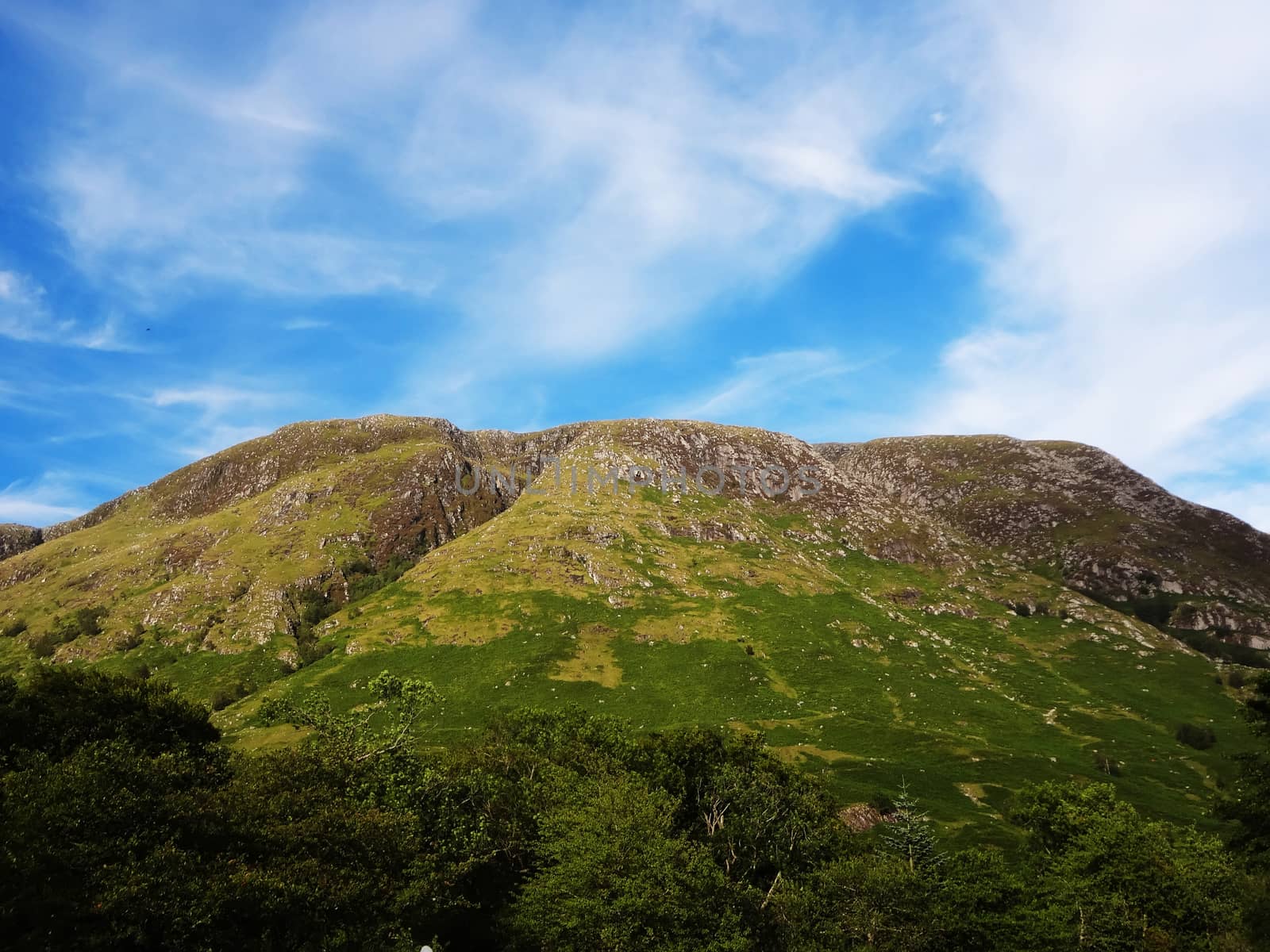 Scottish Highlands, mountain valley with blue sky