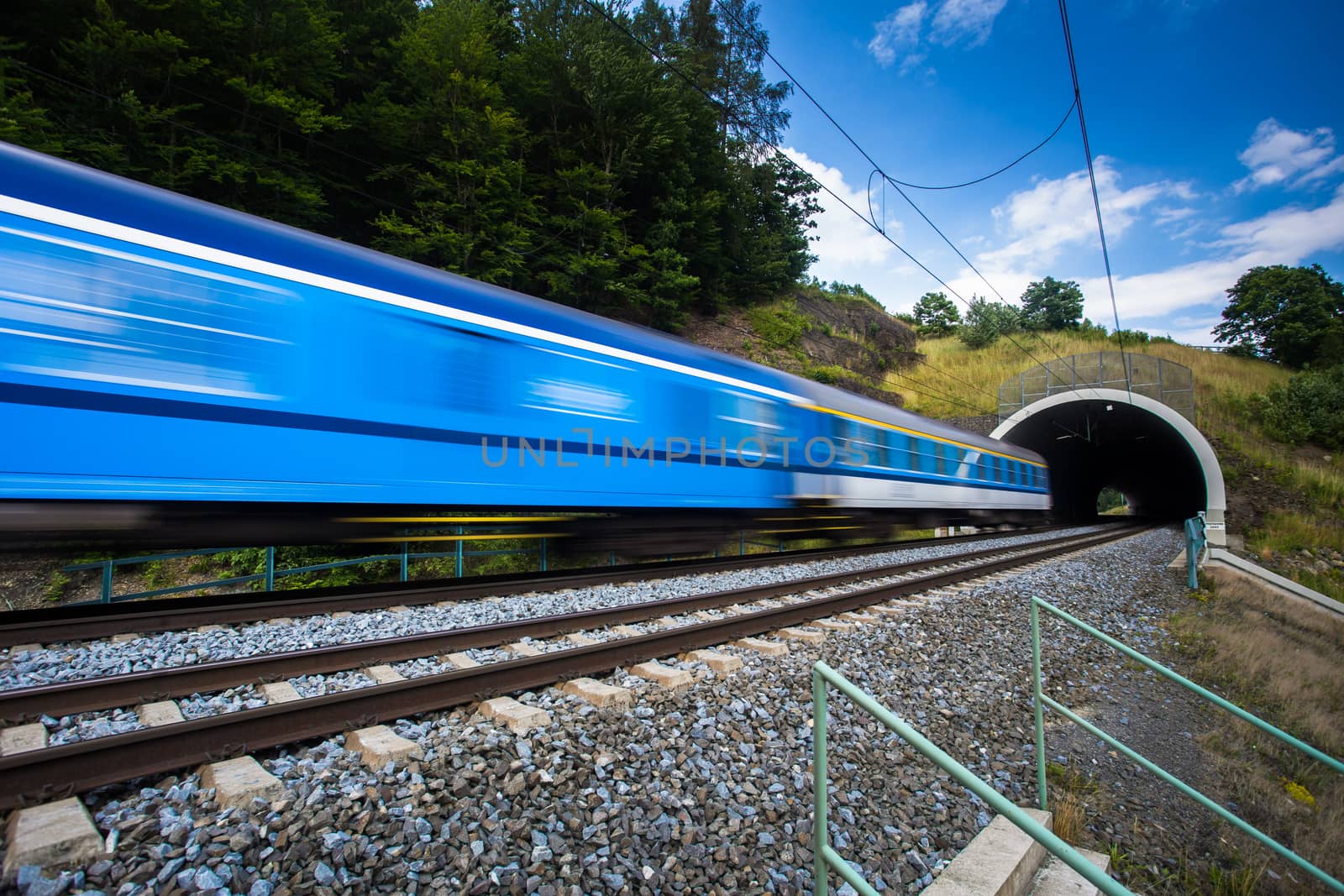 Fast train passing through a tunnel on a lovely summer day by viktor_cap