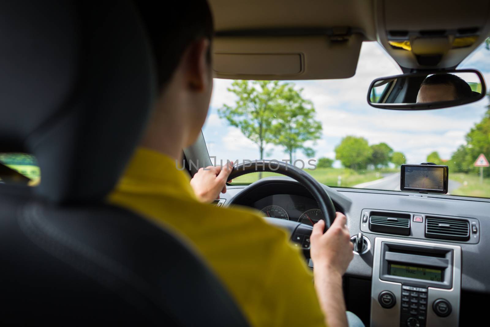 Man driving a car with his hands on the steering wheel