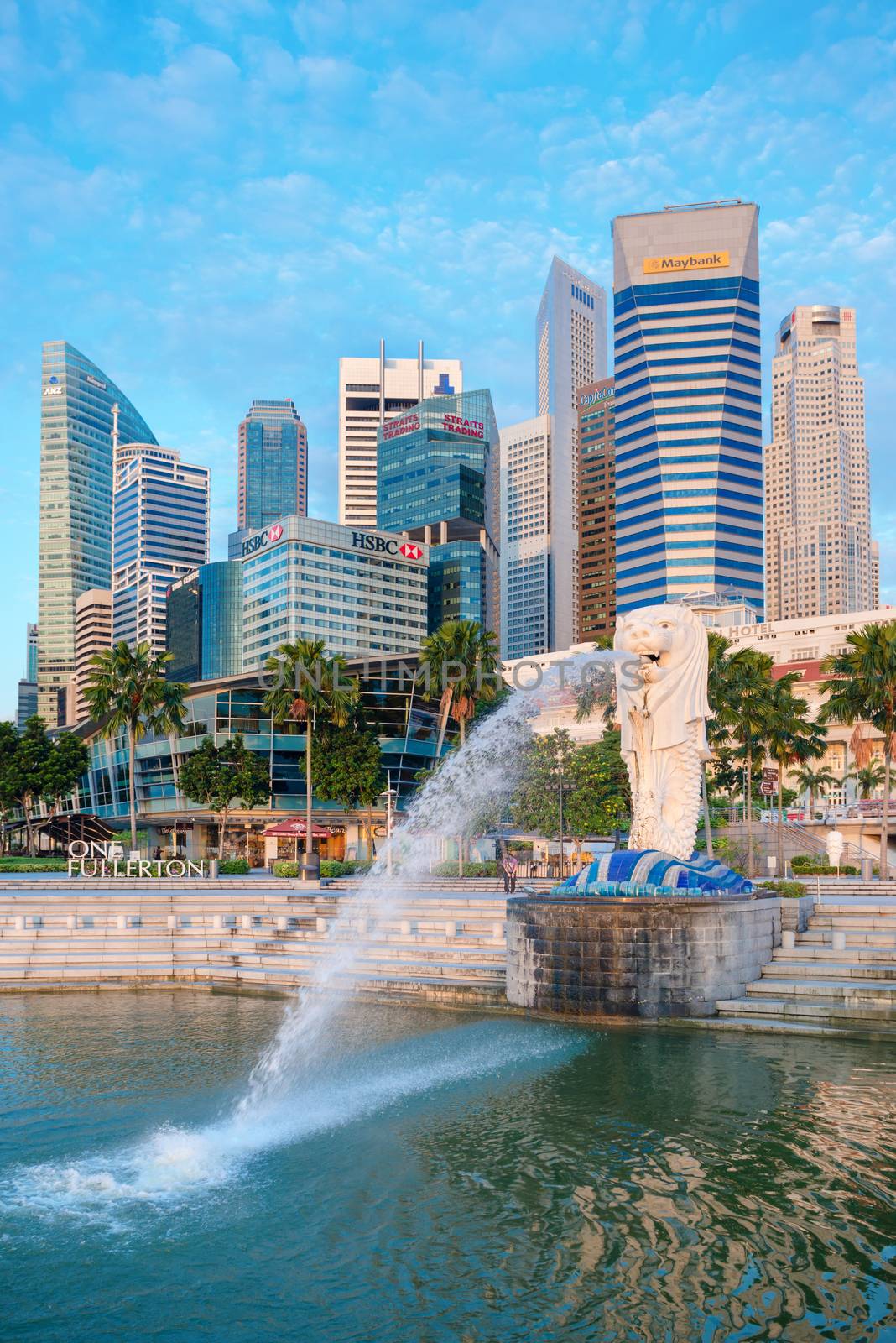 SINGAPORE -  JAN 01, 2014:  The Merlion fountain and Marina Bay on morning. Merlion is a mythical creature with the head of a lion and the body of a fish is a symbol of Singapore.