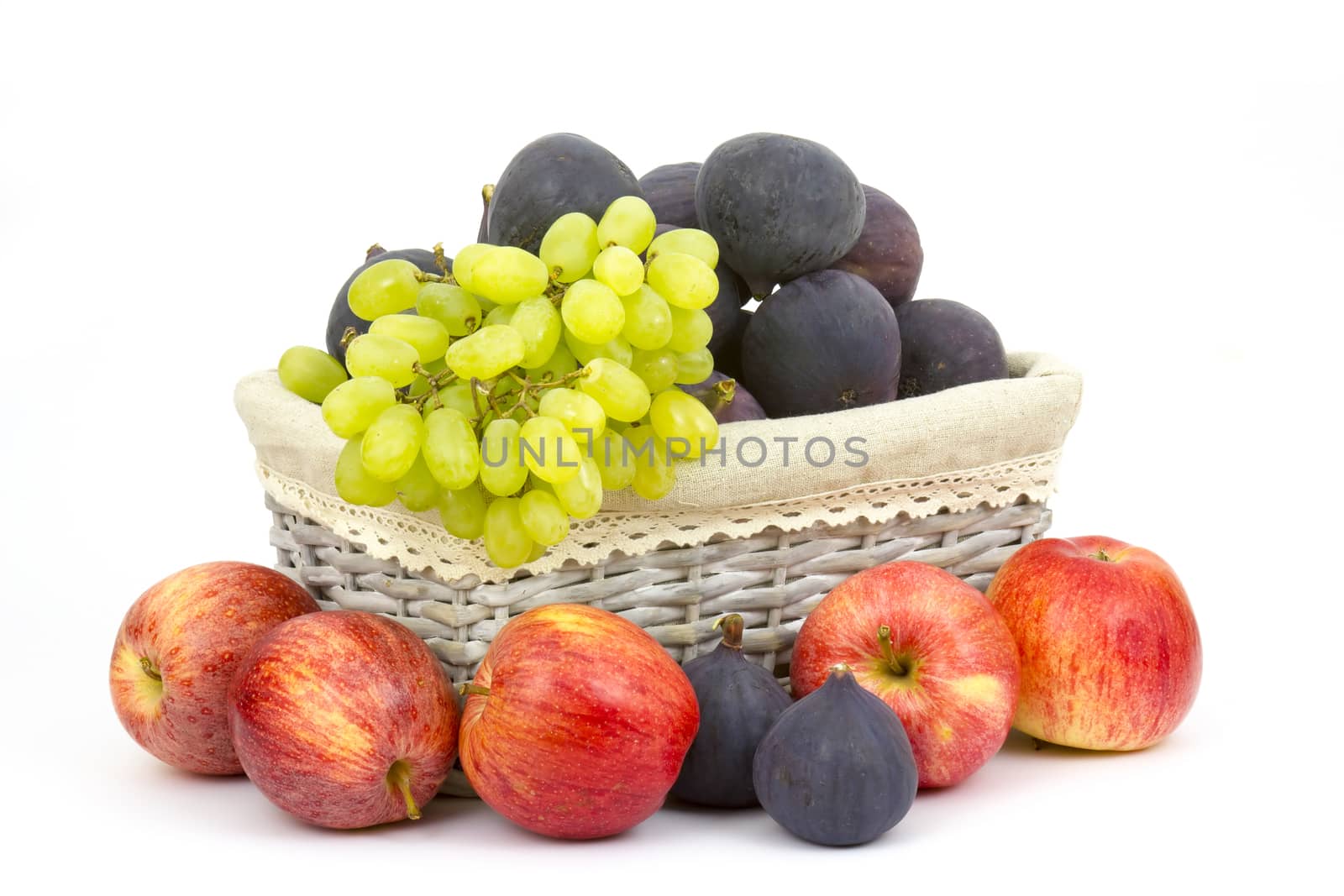 fresh fruits in a basket on white background