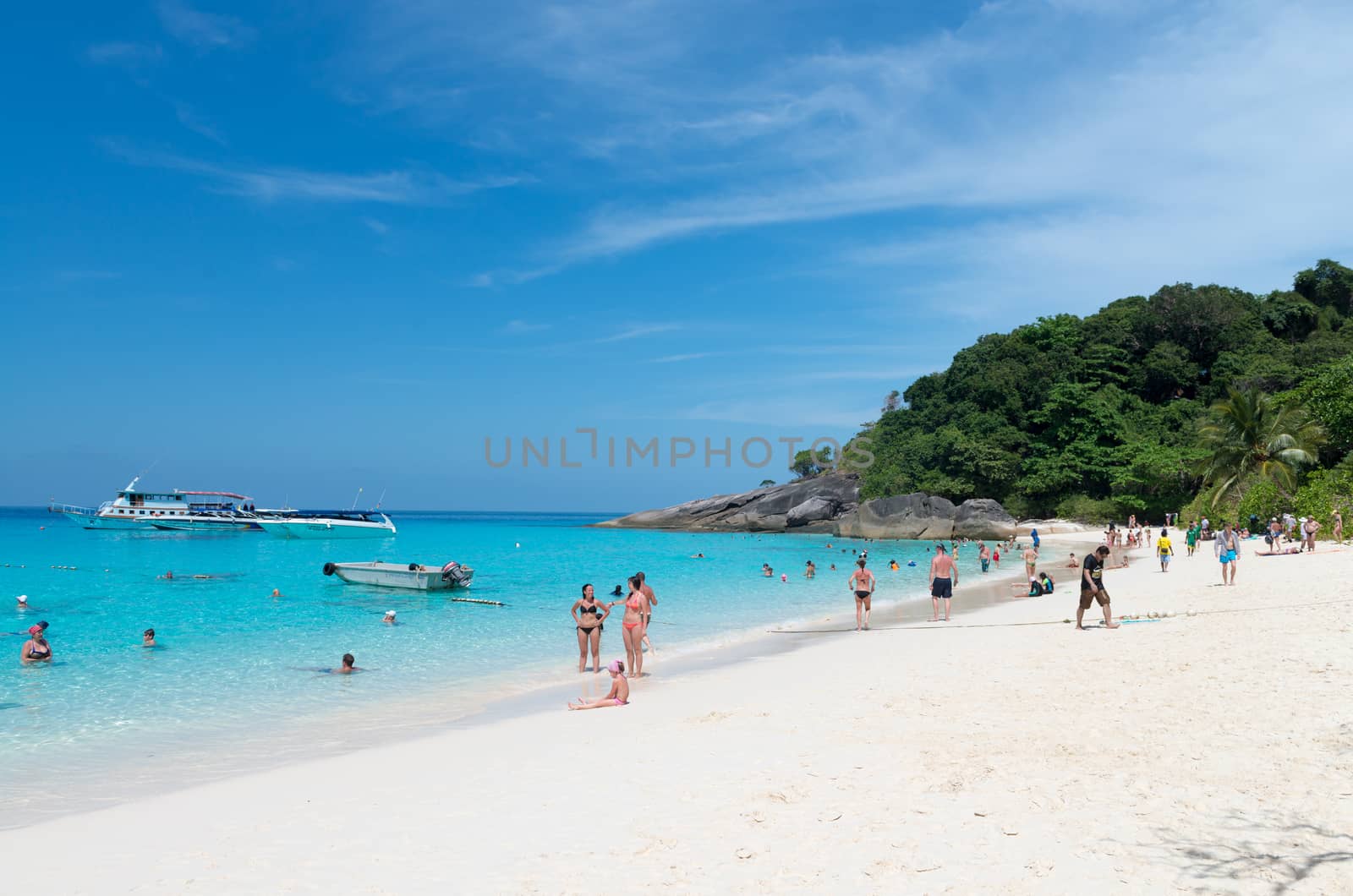 Tourists relax on idyllic tropical beach by iryna_rasko