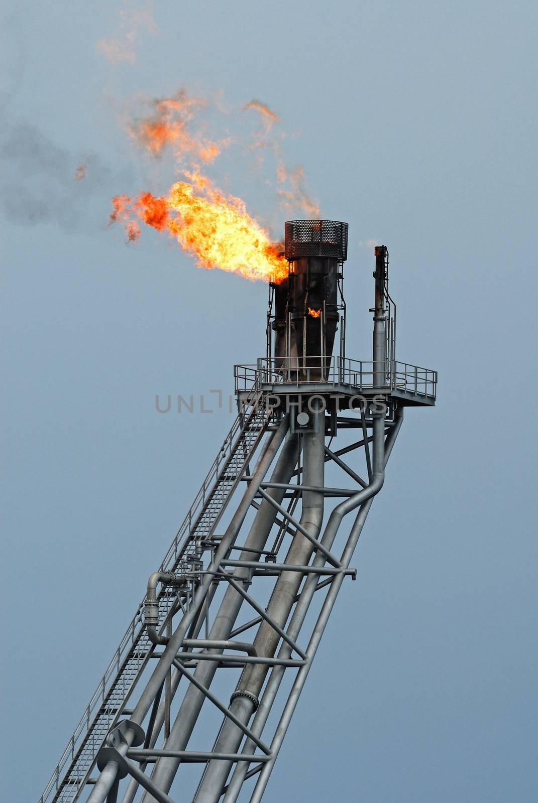 Flare boom nozzle and fire on offshore oil rig by think4photop
