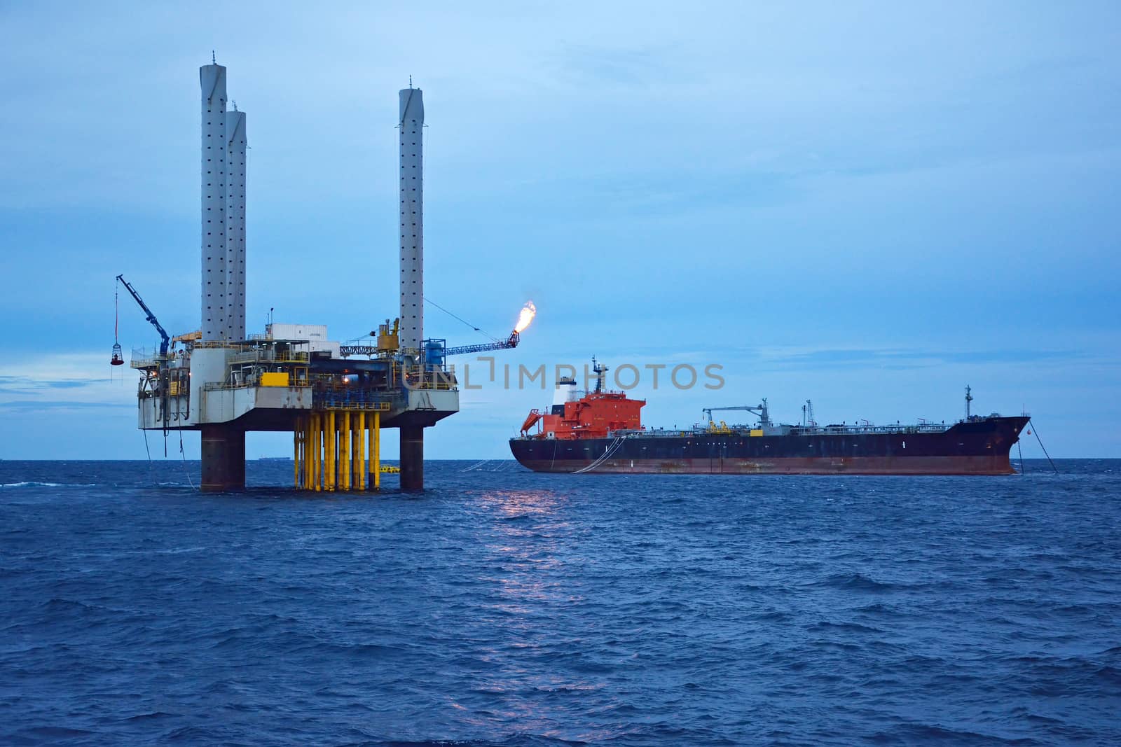 The offshore oil rig in early morning, Gulf of Thailand. by think4photop
