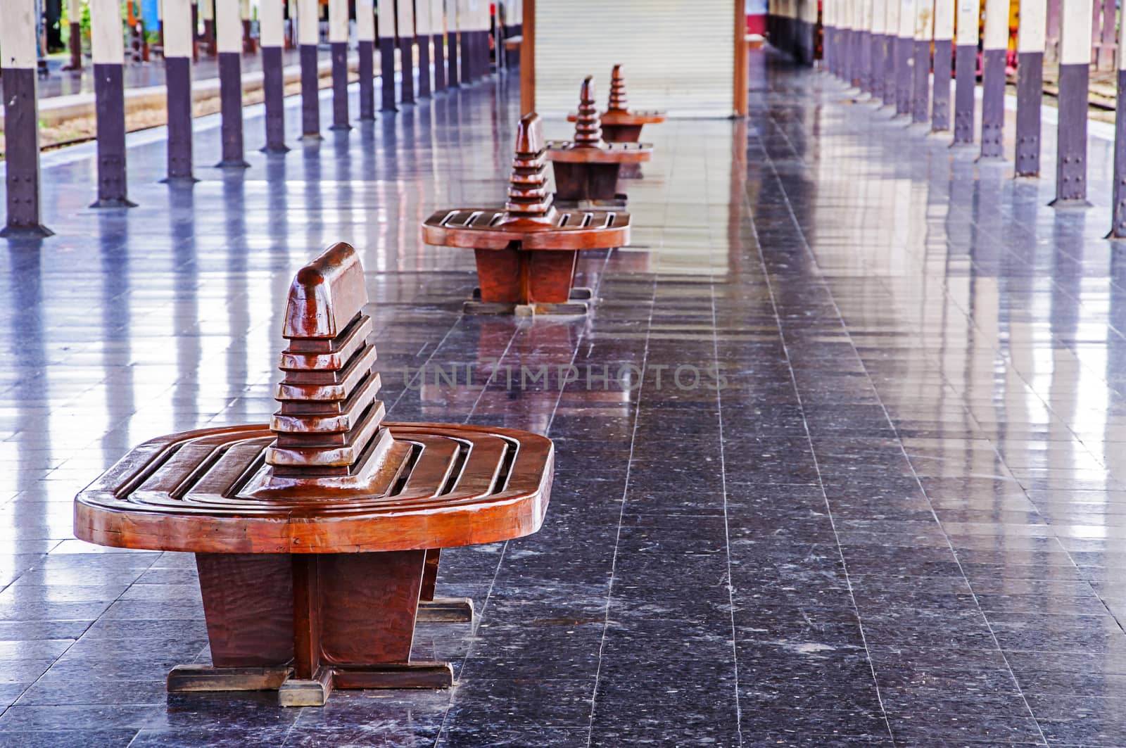 Ancient teak chairs, platform seat at railway station