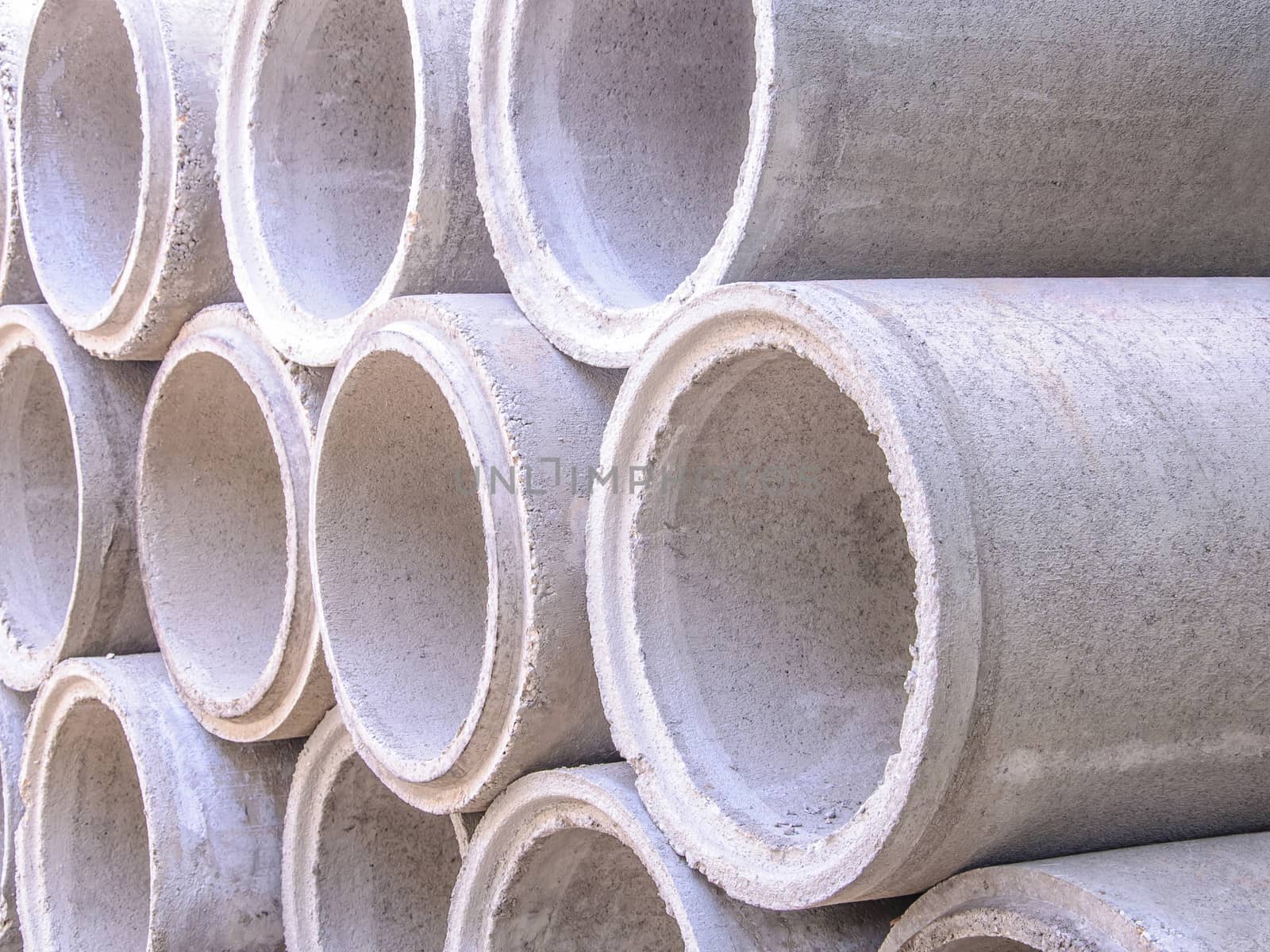 Concrete drainage pipes stacked on construction site