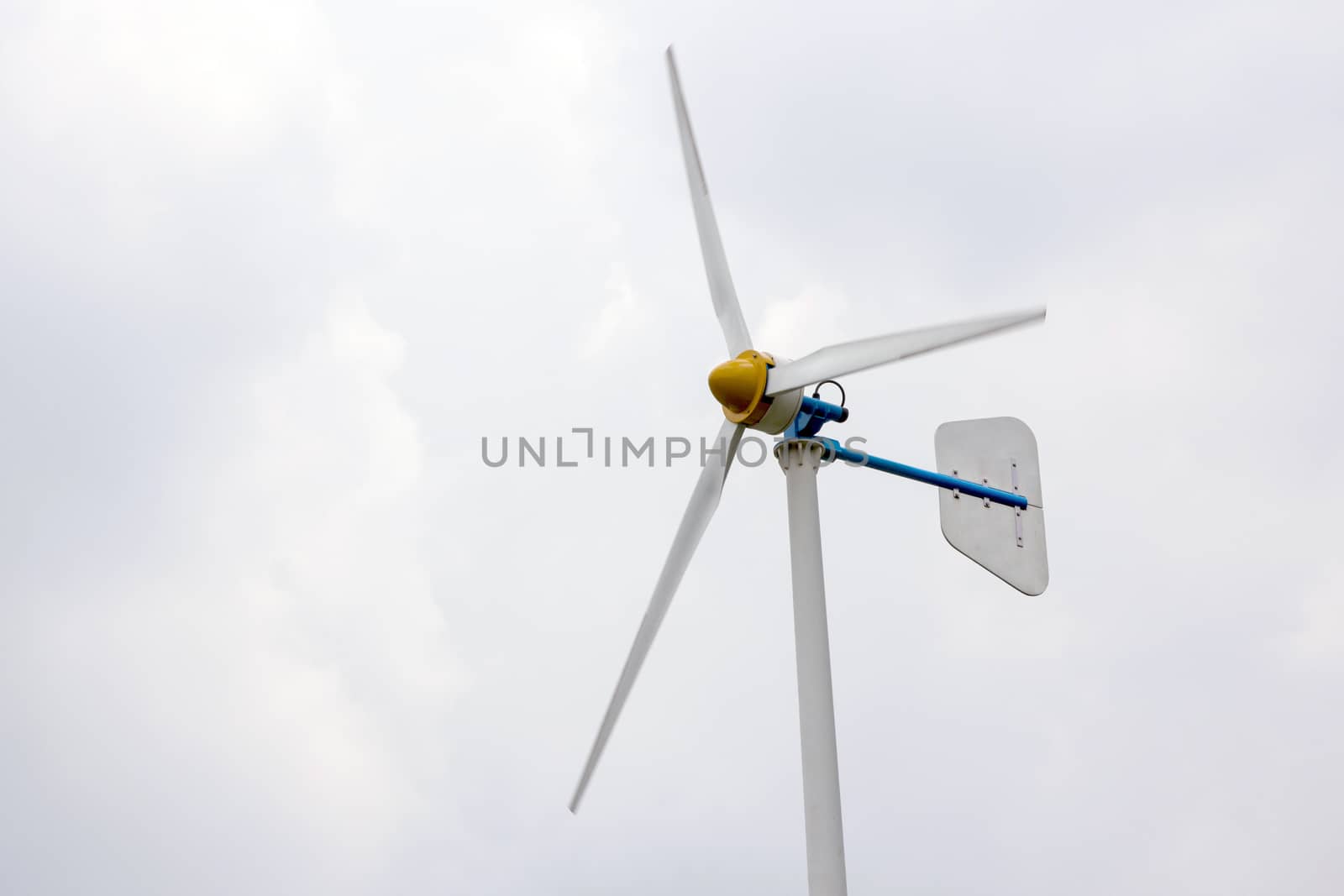 Wind turbine against cloudy sky