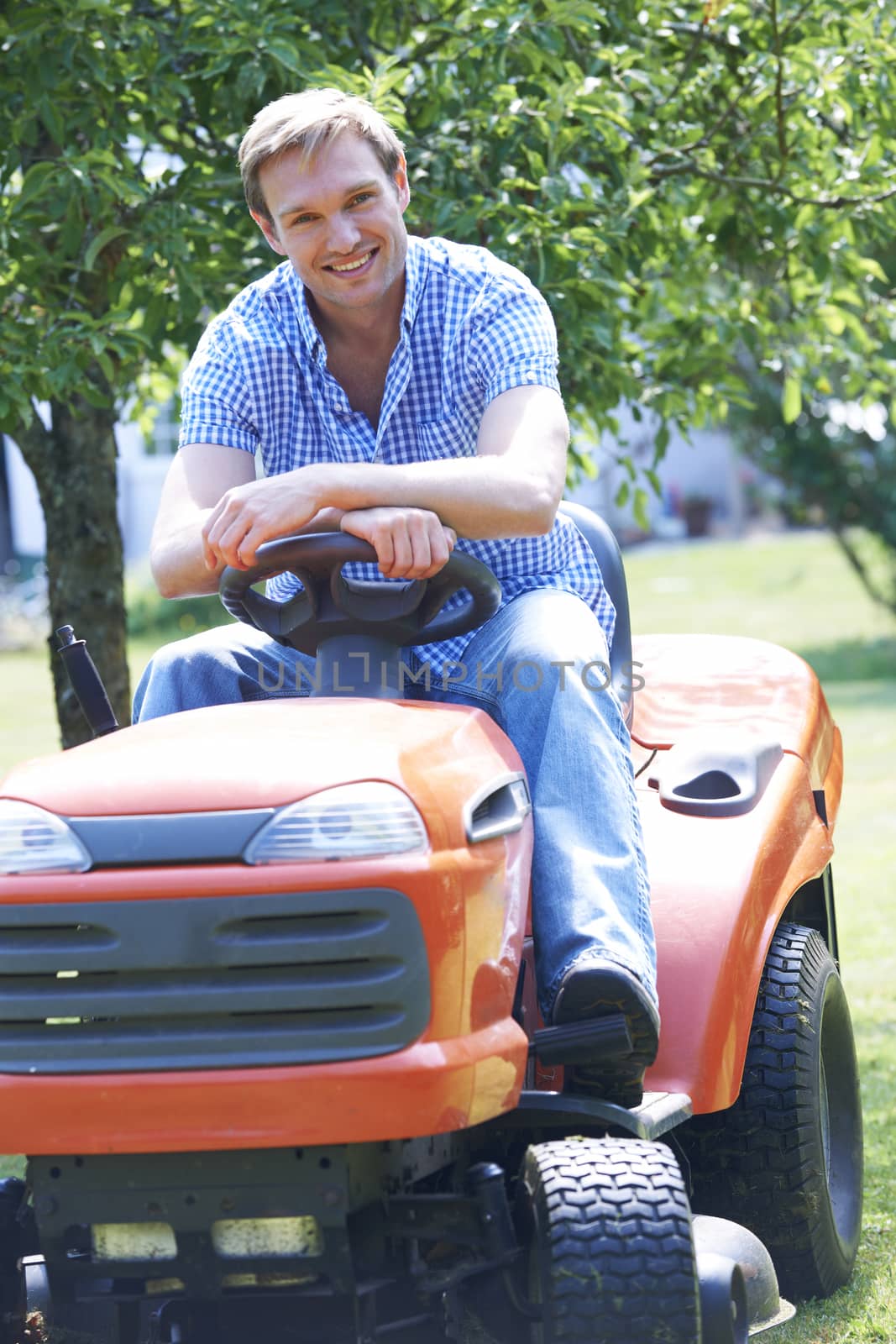 Man Cutting Grass Using Sit On Mower