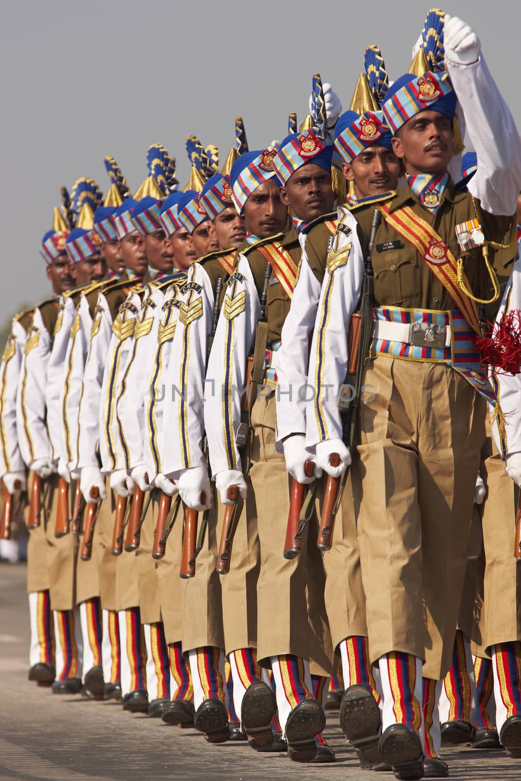 Soldiers in bright blue headdress parading down the Raj Path in preparation for the annual Republic Day Parade in New Delhi, India