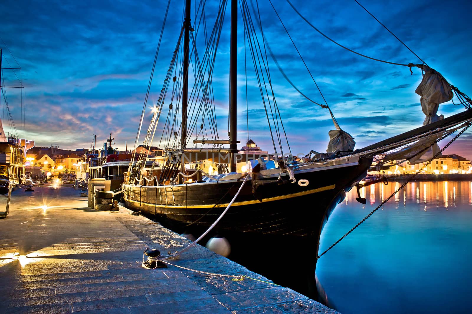 Old wooden boat in Vodice harbor, night view, Dalmatia, Croatia