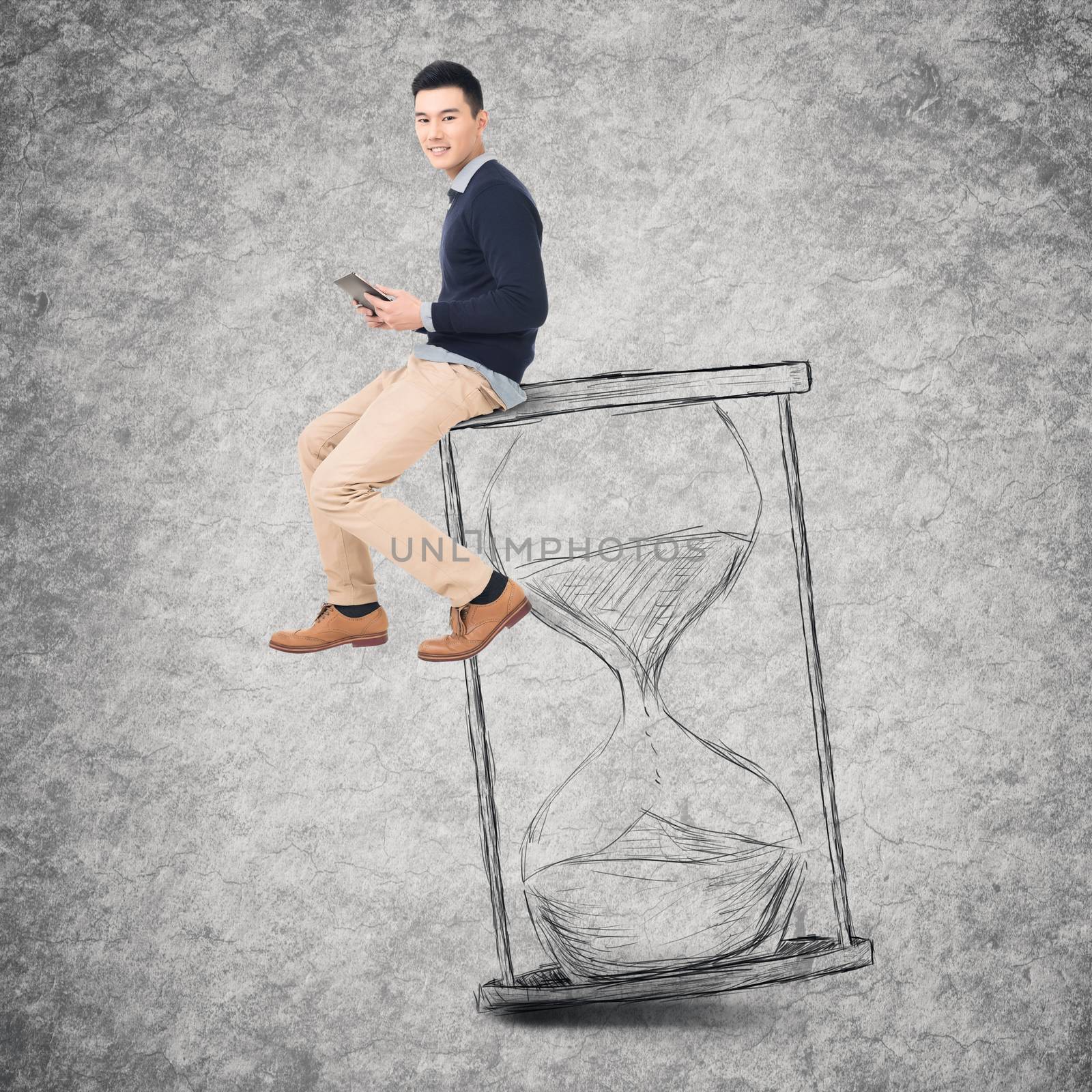 Asian young man sit on a hourglass and use tablet, concept of time management, technology, plan etc.